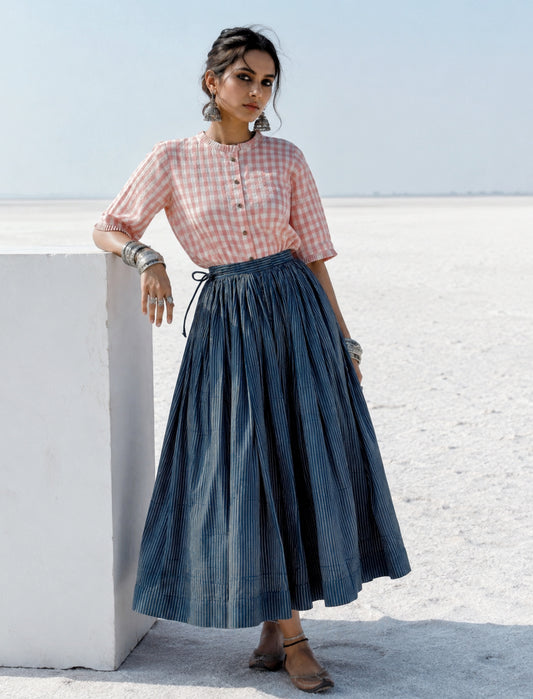 Cotton indigo dyed Ajrakh hand block printed stripes skirt with gathered waistband, adjustable tie strings and concealed side zip in a flowing ankle-length silhouette.