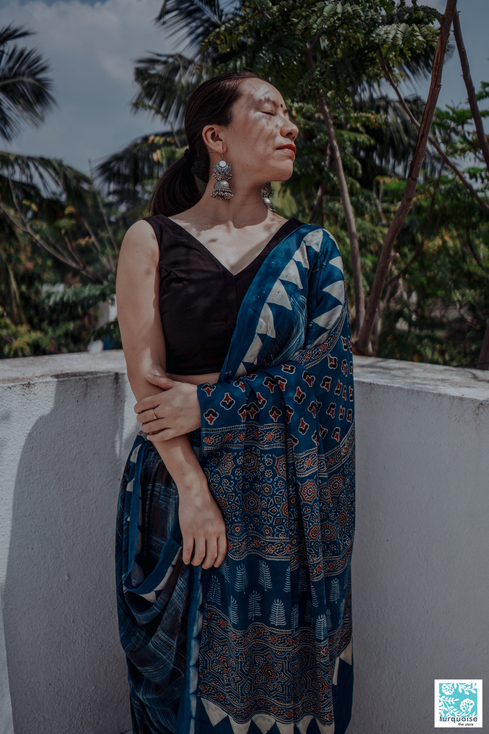 Indigo Ajrakh modal silk saree with natural dye, hand block printed brush-stroke patterns and traditional Ajrakh motifs. Slow-made, handcrafted saree in modal silk, 5.75 meters long, 44-inch width, includes blouse piece.