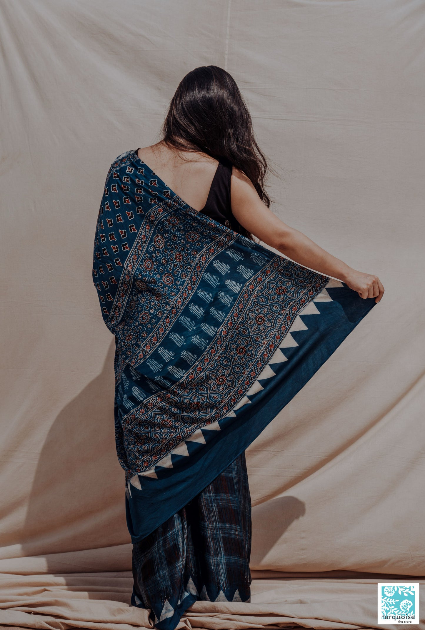 Indigo Ajrakh modal silk saree with natural dye, hand block printed brush-stroke patterns and traditional Ajrakh motifs. Slow-made, handcrafted saree in modal silk, 5.75 meters long, 44-inch width, includes blouse piece.