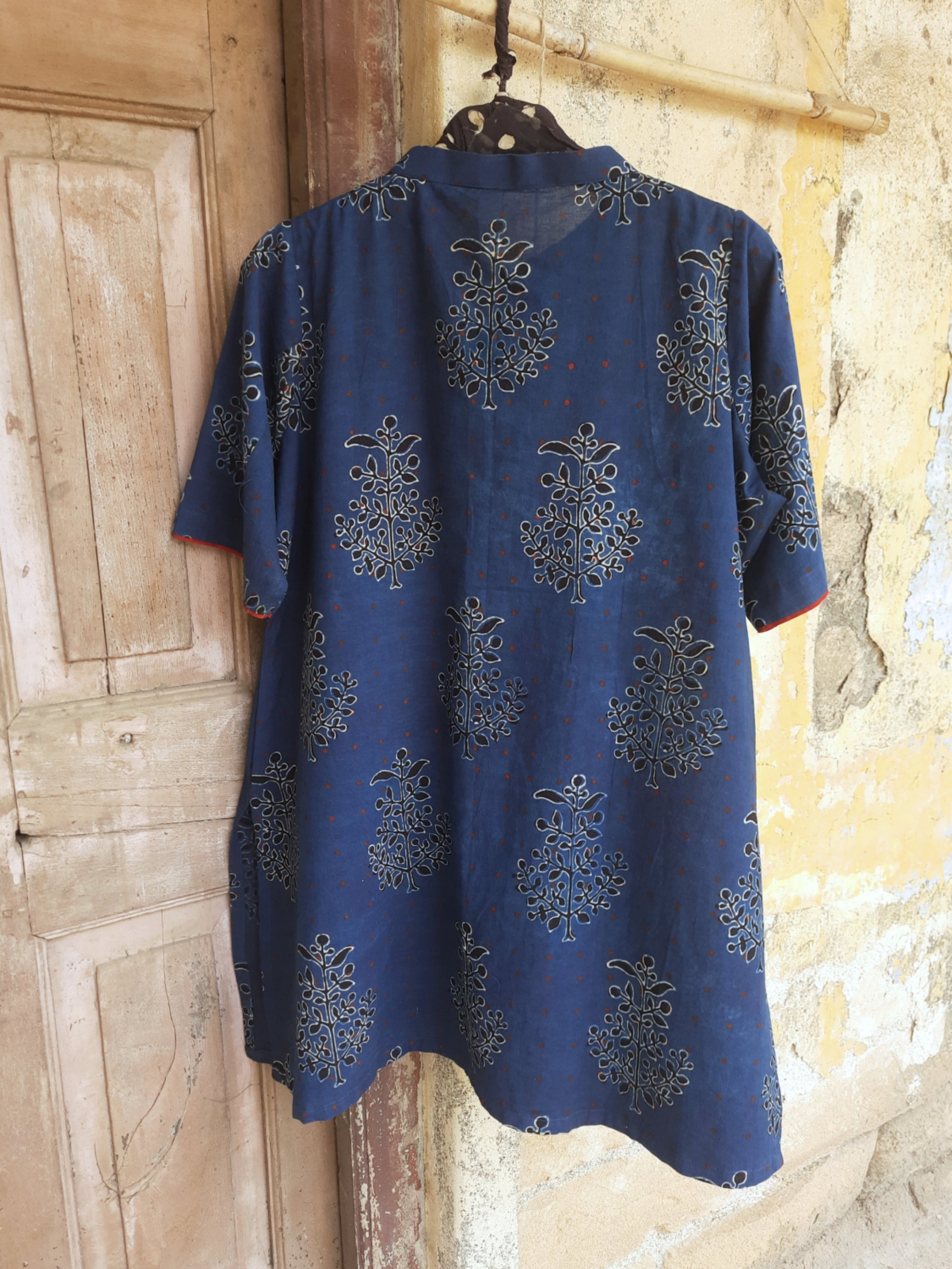 Indigo dyed Ajrakh hand block printed cotton short kurta for women featuring a mandarin collared neck, short sleeves and comfort fit, handcrafted using natural dyes for breathable everyday wear.