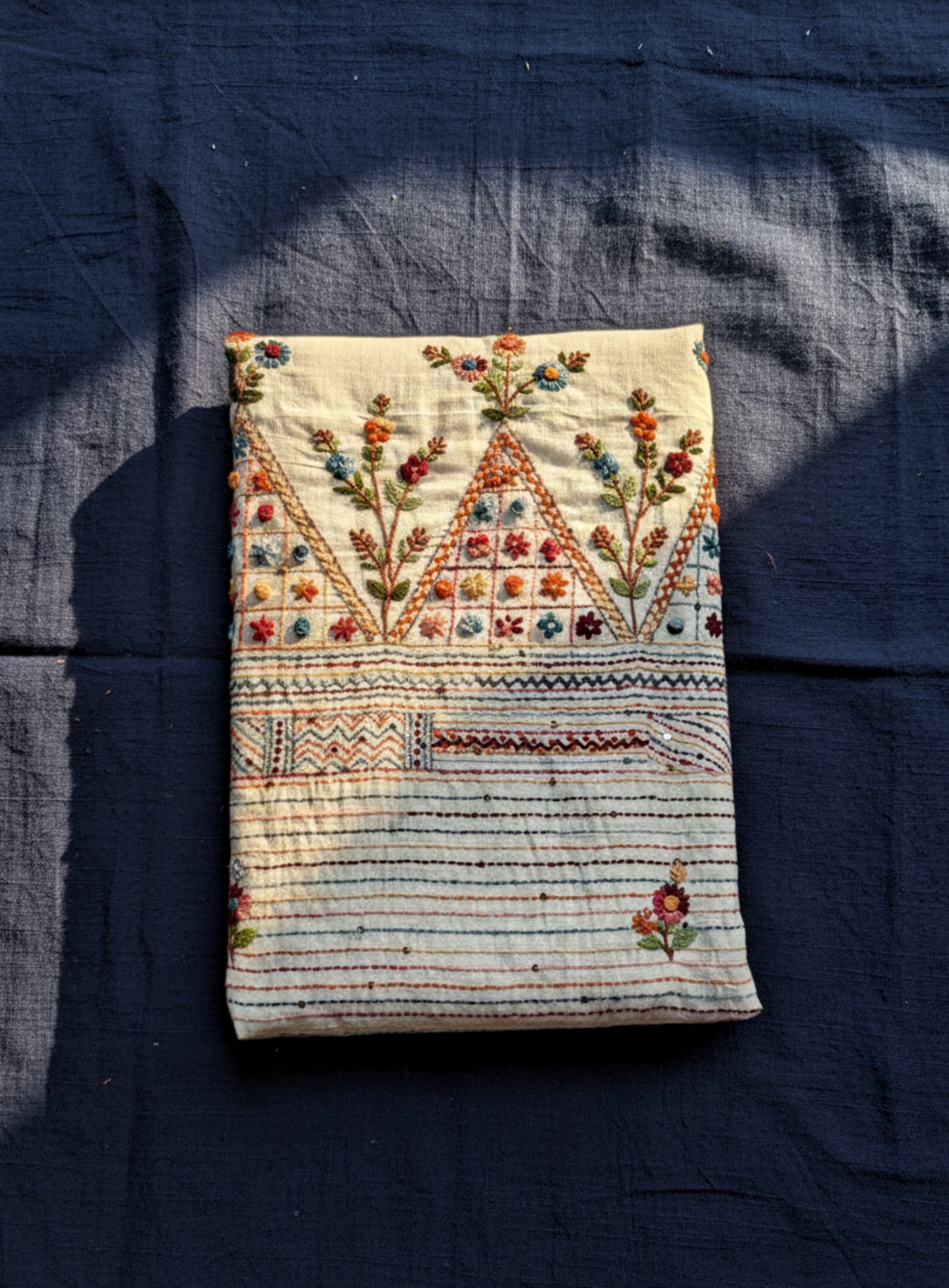 Handspun and handwoven cotton saree in warm ivory shade, featuring delicate hand embroidered floral and linear motifs with subtle sequin detailing. Slow made artisanal saree named Kusum, paired with a hand embroidered blouse piece.