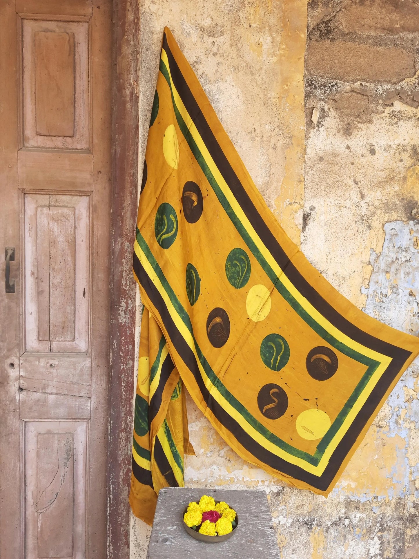 Handcrafted turmeric-yellow Ajrakh modal silk stole with cosmic moon block-printed motifs, naturally dyed with pure turmeric. Soft, elegant drape with artisanal detailing, perfect for sustainable handmade styling.