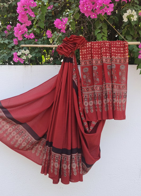 Madder red cotton Ajrakh hand block print saree featuring a solid dyed body, intricately printed Ajrakh borders, and a richly patterned pallu, naturally dyed using madder with a running blouse piece, handcrafted in India.