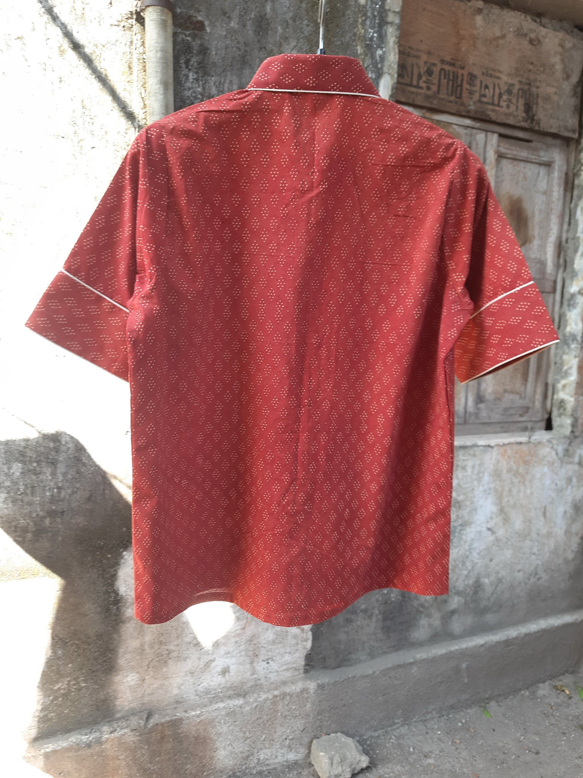 Madder dyed Ajrakh hand block printed cotton shirt for women in deep red tone, crafted in breathable pure cotton with a collared neck and contrast piping, naturally dyed and handmade for everyday comfort.