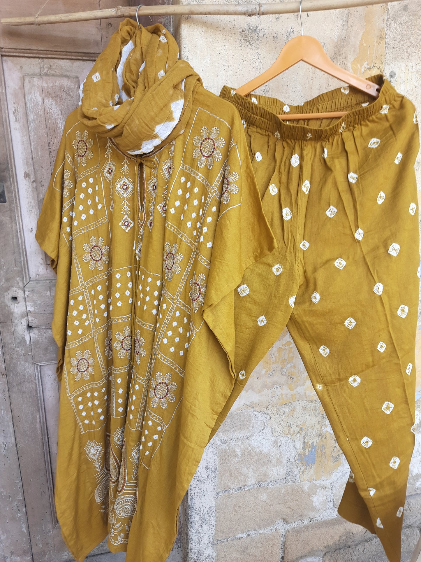 Mustard Bandhani embroidered three-piece set with kaftan, cotton satin pants, and dupatta, handcrafted at Turquoisethestore.