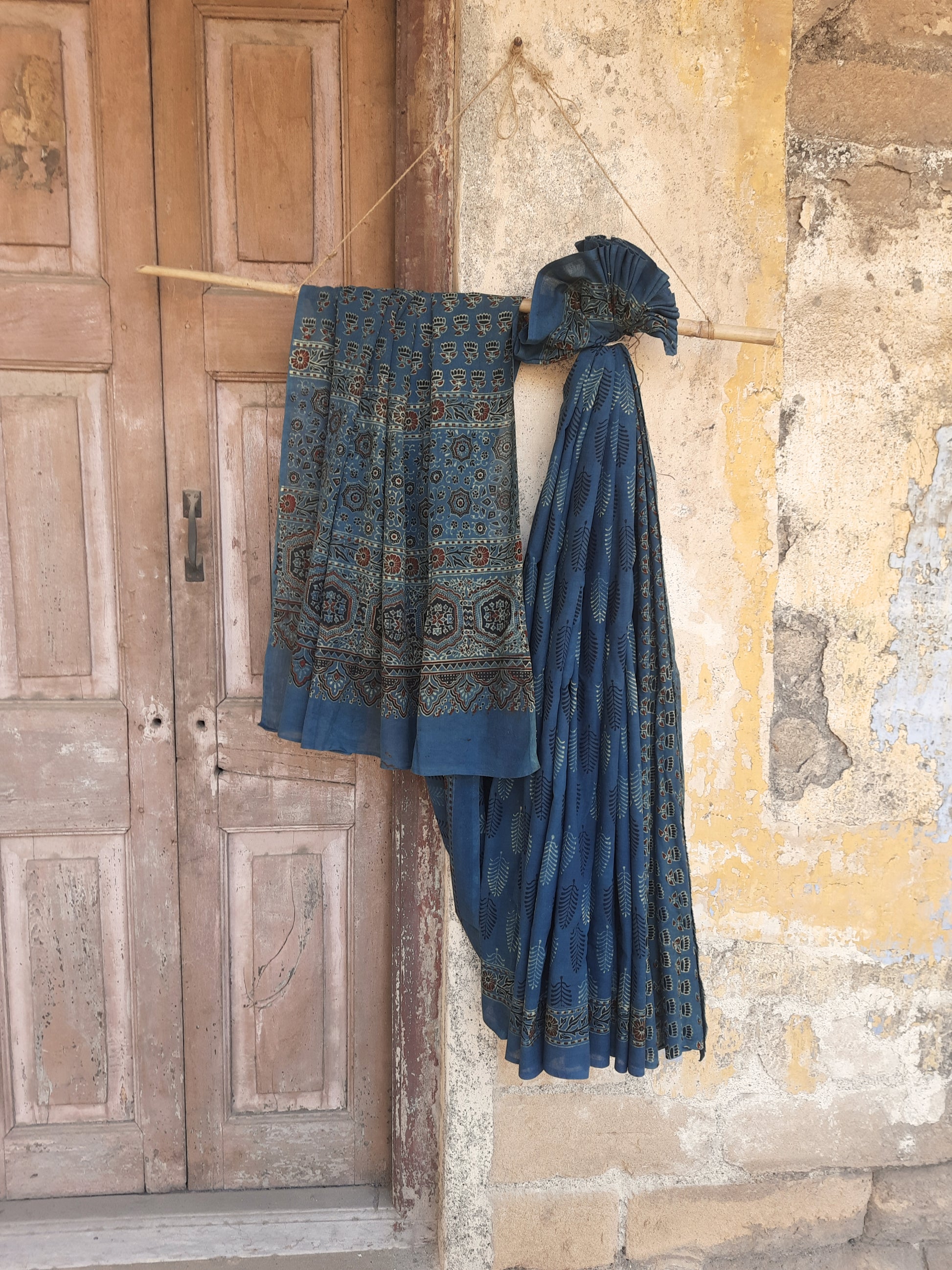 Naturally dyed green cotton Ajrakh hand block print saree with all-over traditional motifs, detailed Ajrakh borders, and a richly patterned pallu, handcrafted in India using age-old techniques.