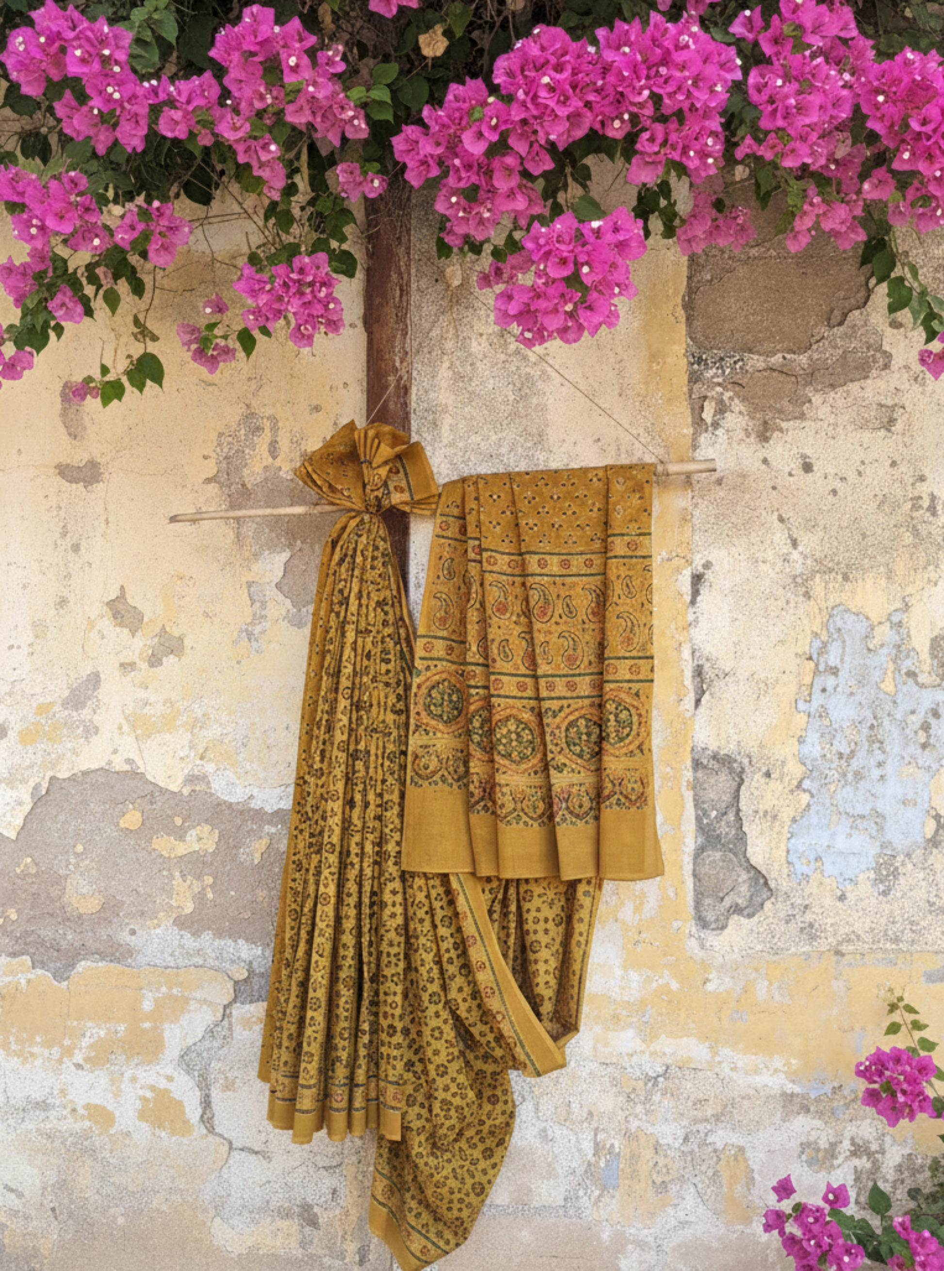Turmeric dyed Ajrakh hand block printed cotton saree crafted using traditional wooden blocks. Natural dyed, breathable and slow made saree featuring intricate Ajrakh patterns with a running blouse piece, handmade by artisans in Gujarat.