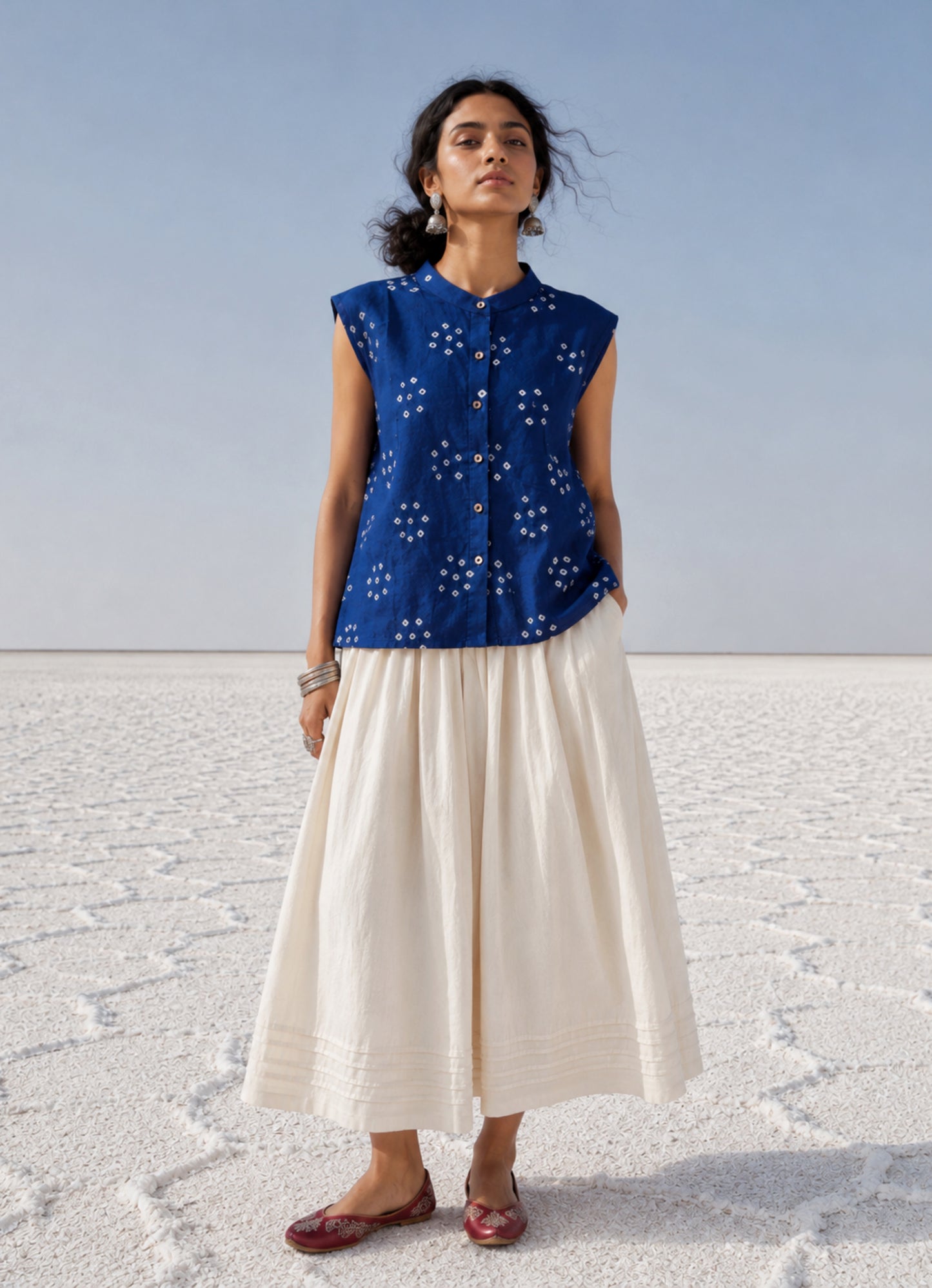 Handspun and handwoven organic cotton sleeveless Bandhani shirt in dusty royal blue with soft mandarin collar, side slits, and relaxed fit.
