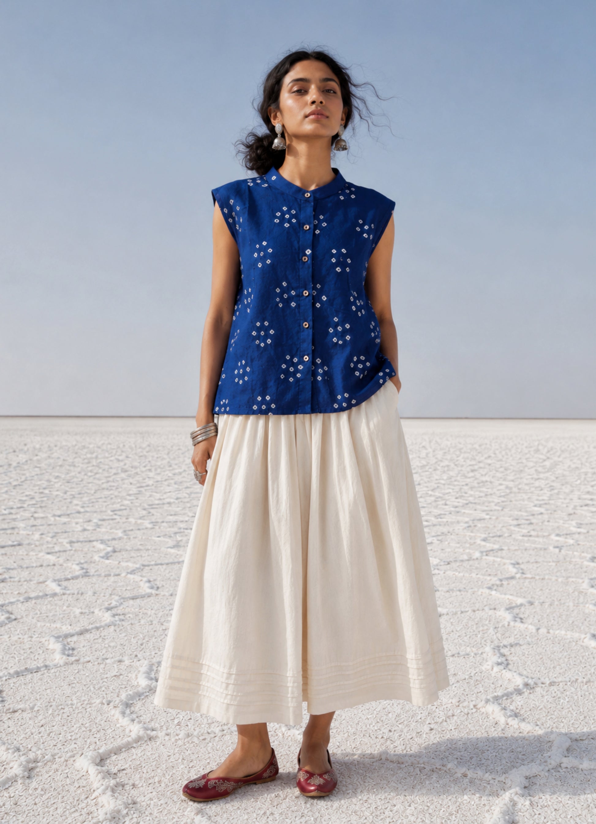 Handspun and handwoven organic cotton sleeveless Bandhani shirt in dusty royal blue with soft mandarin collar, side slits, and relaxed fit.
