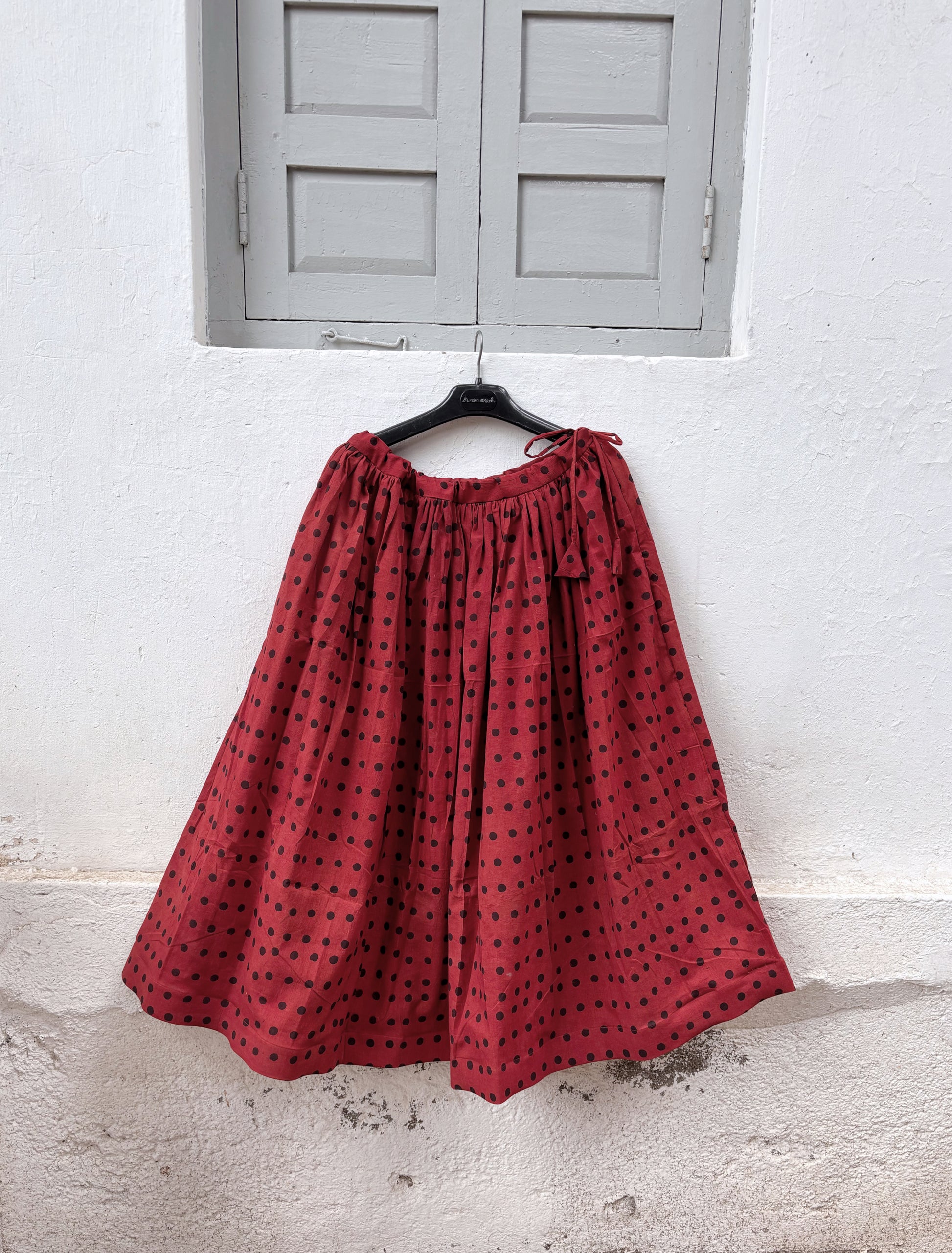 Aaruni madder dyed Ajrakh polka dot cotton coord set with cropped sleeveless shirt and flared skirt
