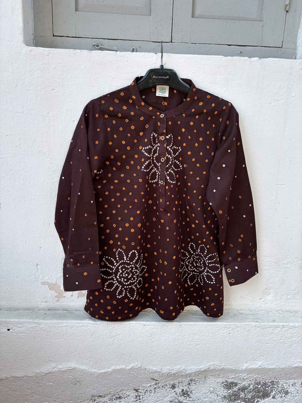 Agnik deep brown cotton shirt with turmeric-yellow and off-white hand tie-dyed Bandhani motifs, soft mandarin collar and partial button placket