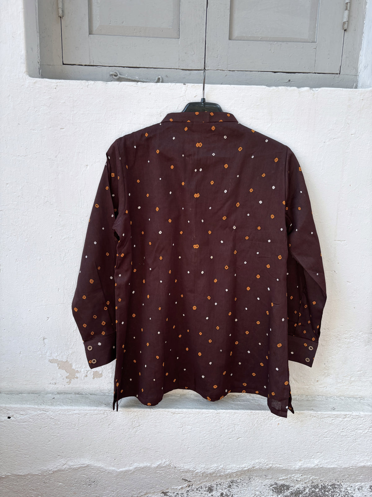 Agnik deep brown cotton shirt with turmeric-yellow and off-white hand tie-dyed Bandhani motifs, soft mandarin collar and partial button placket