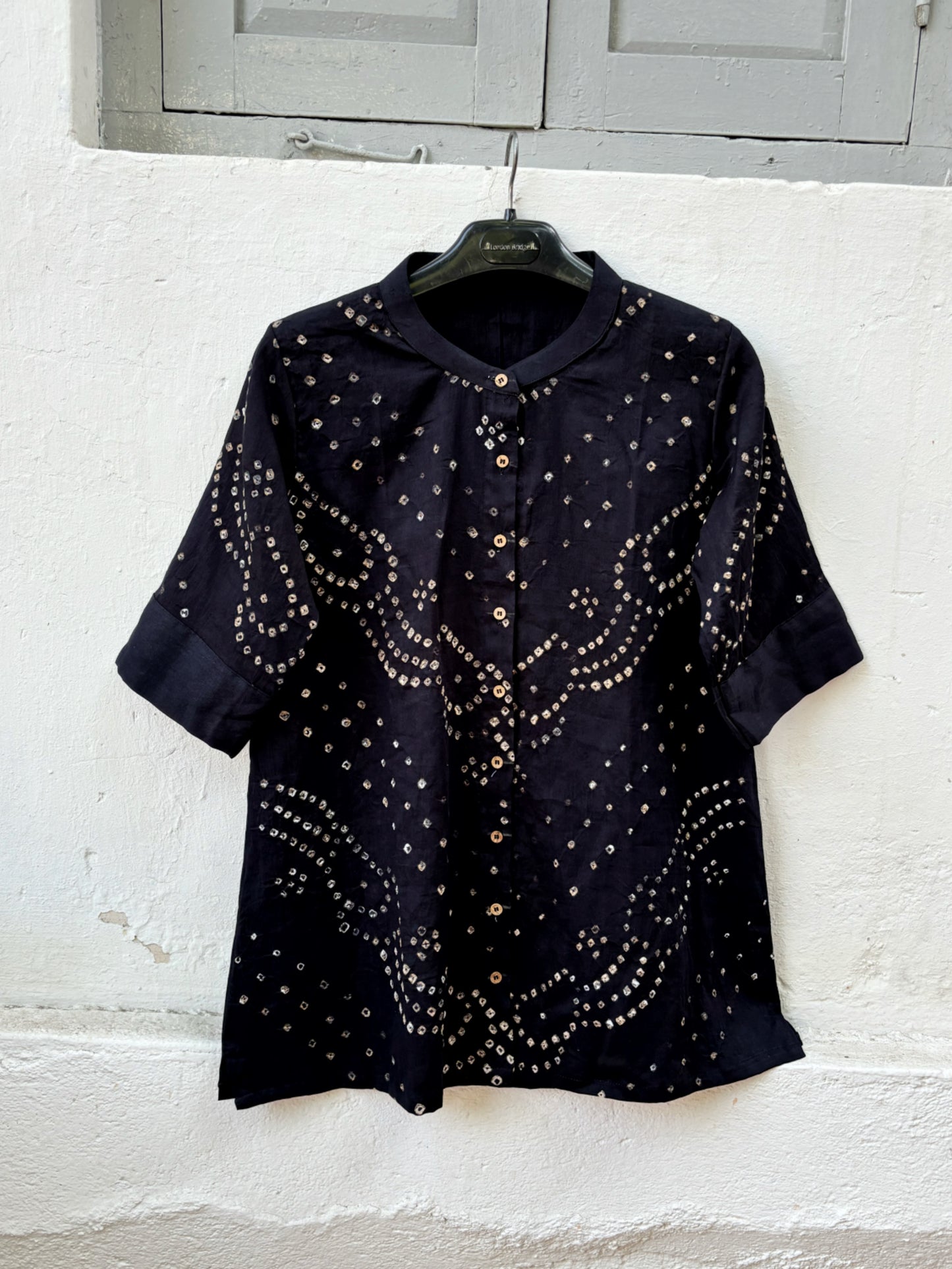 Black Bandhani shirt for women with mandarin collar and cuff sleeves, hand tie dyed ivory patterns on cotton satin, relaxed fit.