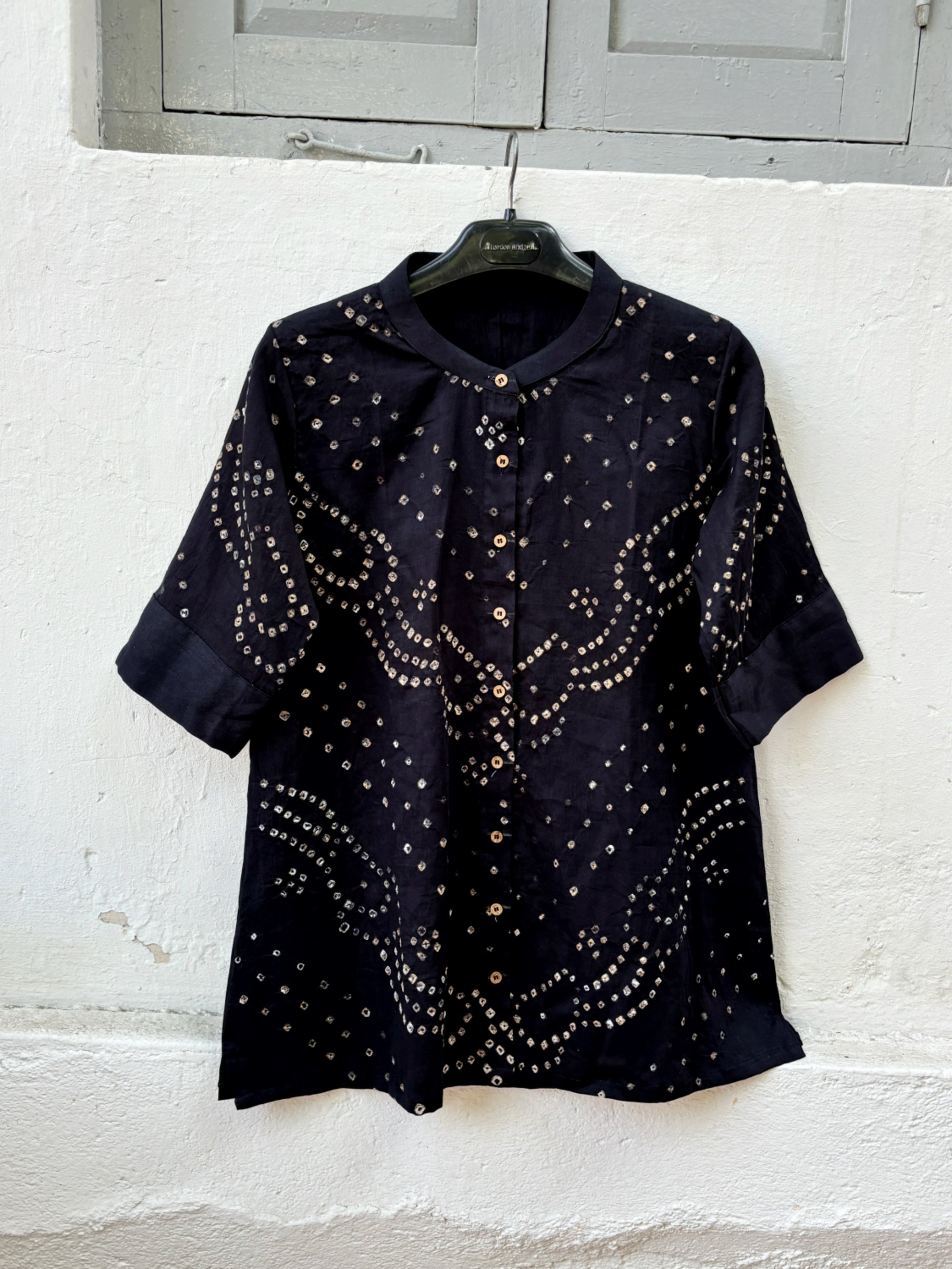 Black Bandhani shirt for women with mandarin collar and cuff sleeves, hand tie dyed ivory patterns on cotton satin, relaxed fit.