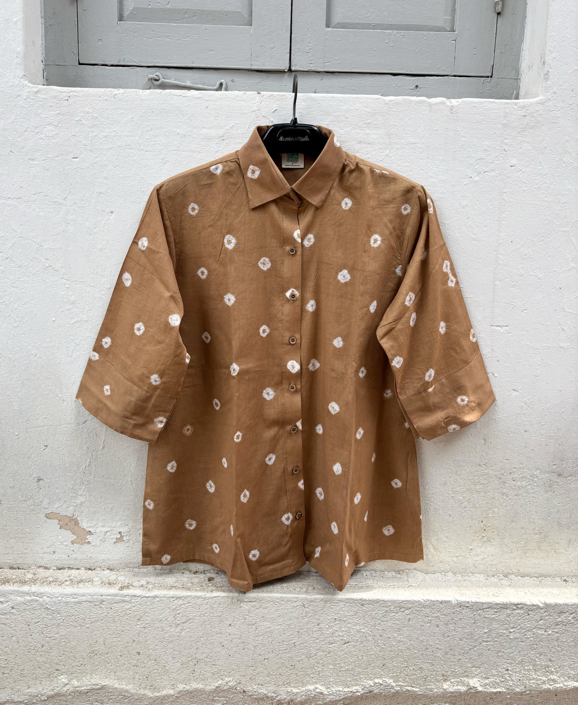 Women's camel brown cotton Bandhani shirt with wooden buttons.