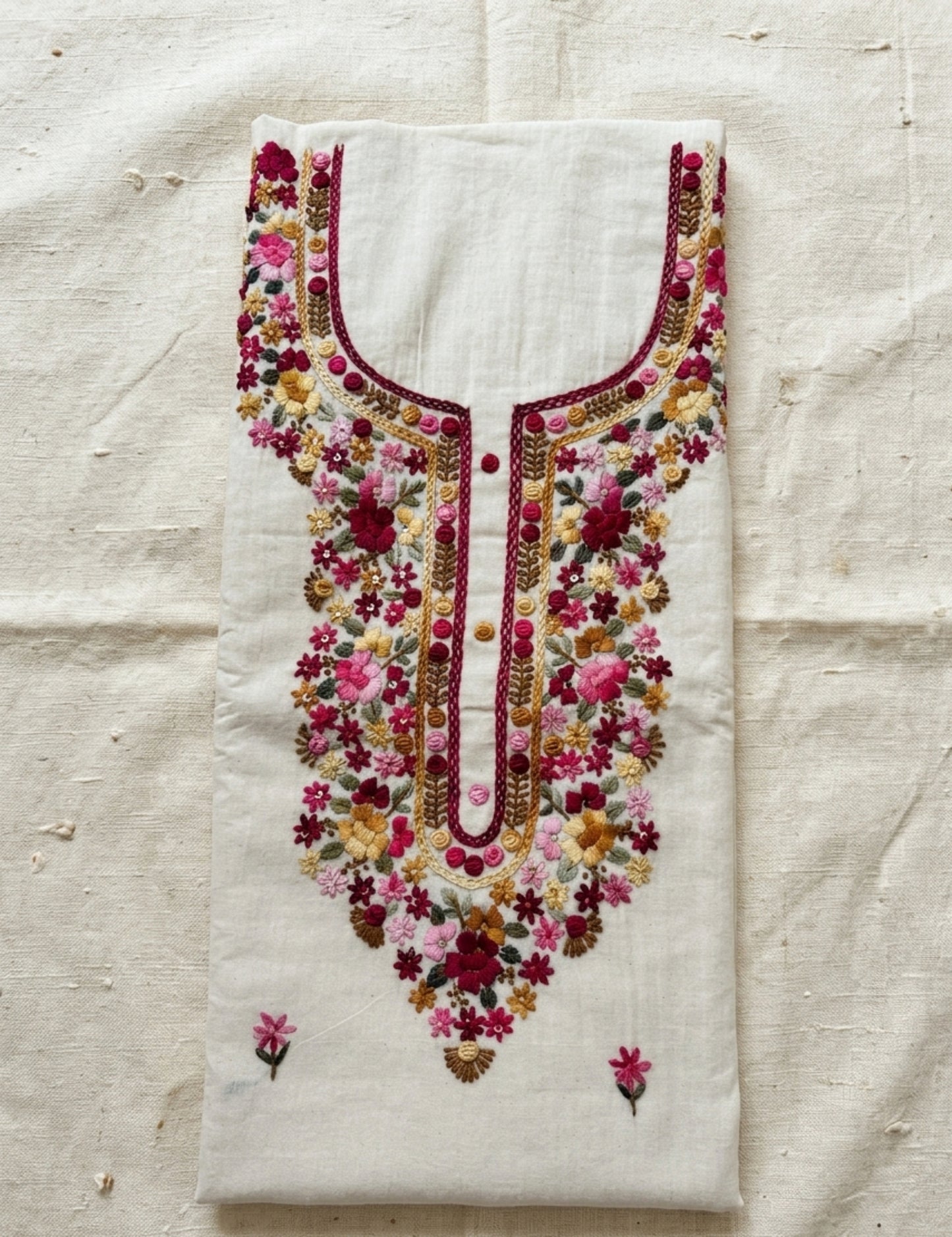 Handspun cotton unstitched kurta featuring a floral hand embroidered yoke in pink and earthy tones, small butti motifs on the kurta.