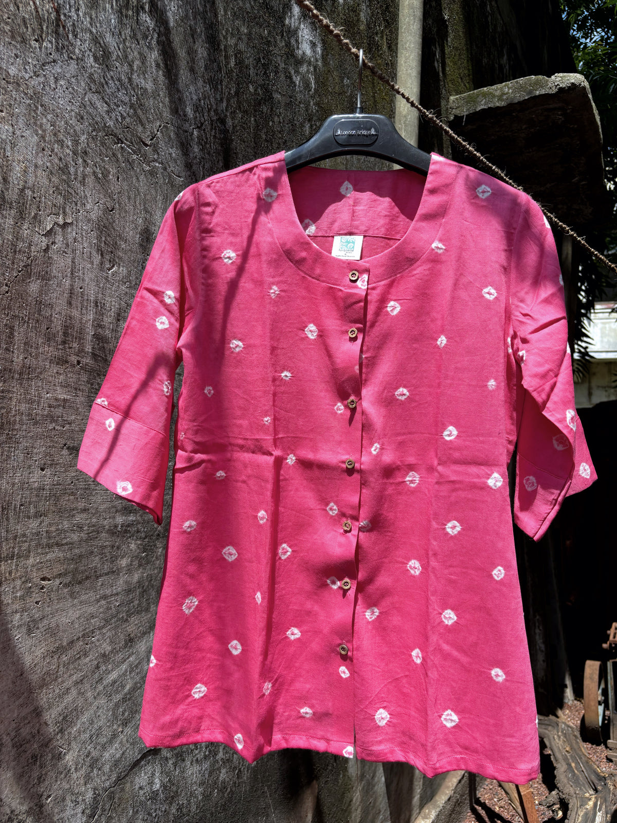 Chhabili gulabi pink Bandhani cotton satin shirt styled with an off-white full-length skirt