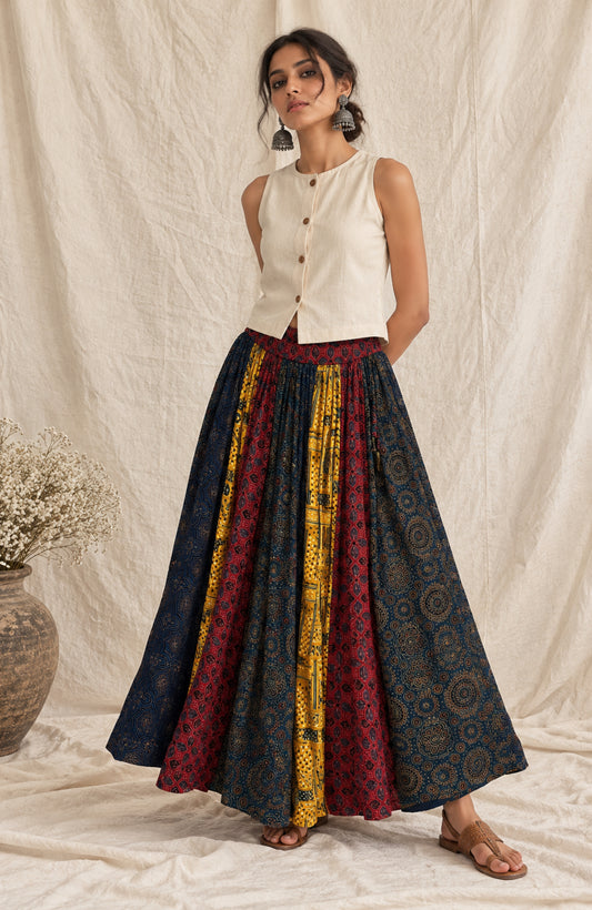 Multi-print natural-dyed Ajrakh modal silk skirt in indigo, wine red and mustard yellow, styled with an ivory sleeveless top