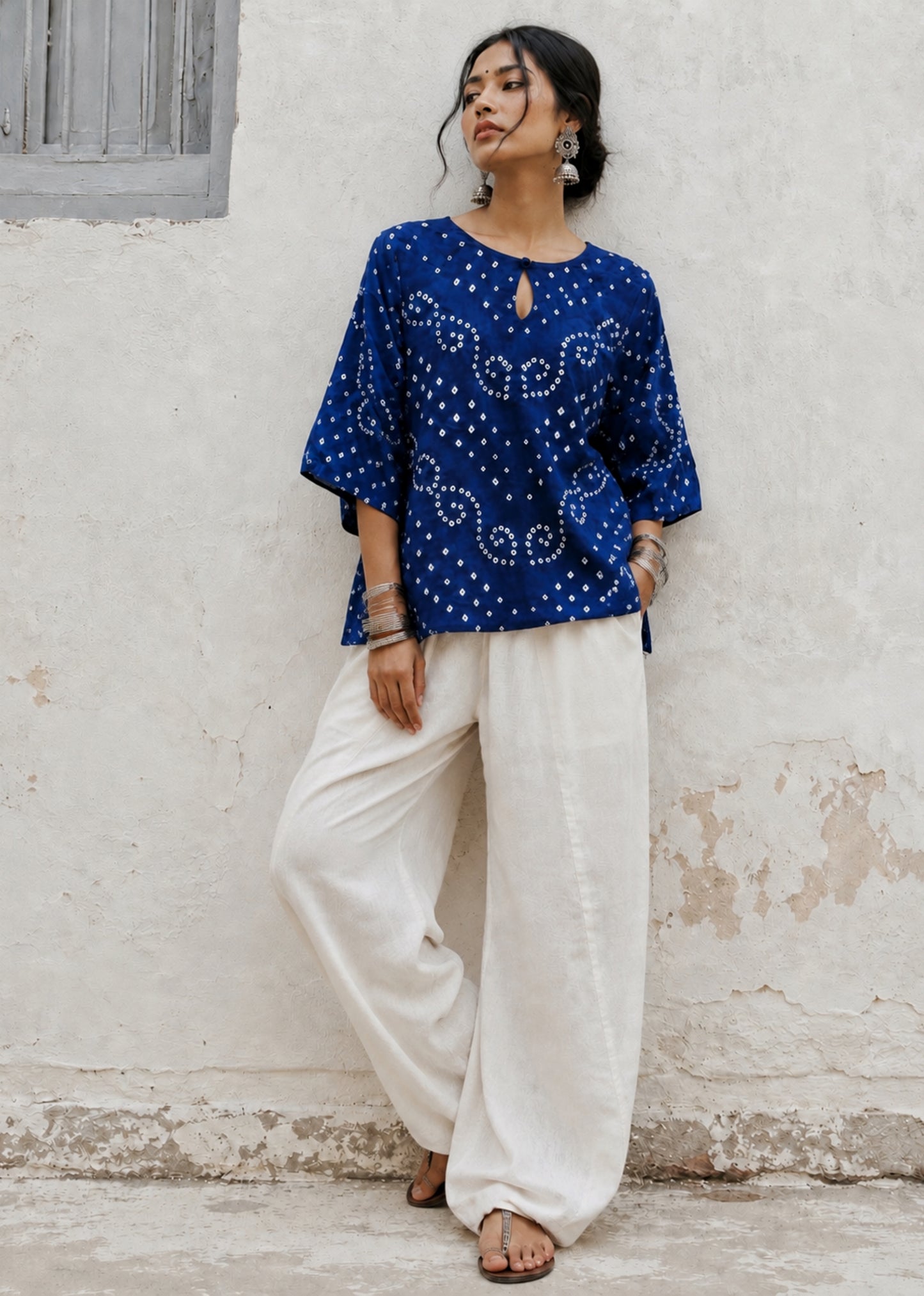 Cobalt blue cotton satin Bandhani shirt with a round neckline and keyhole opening.