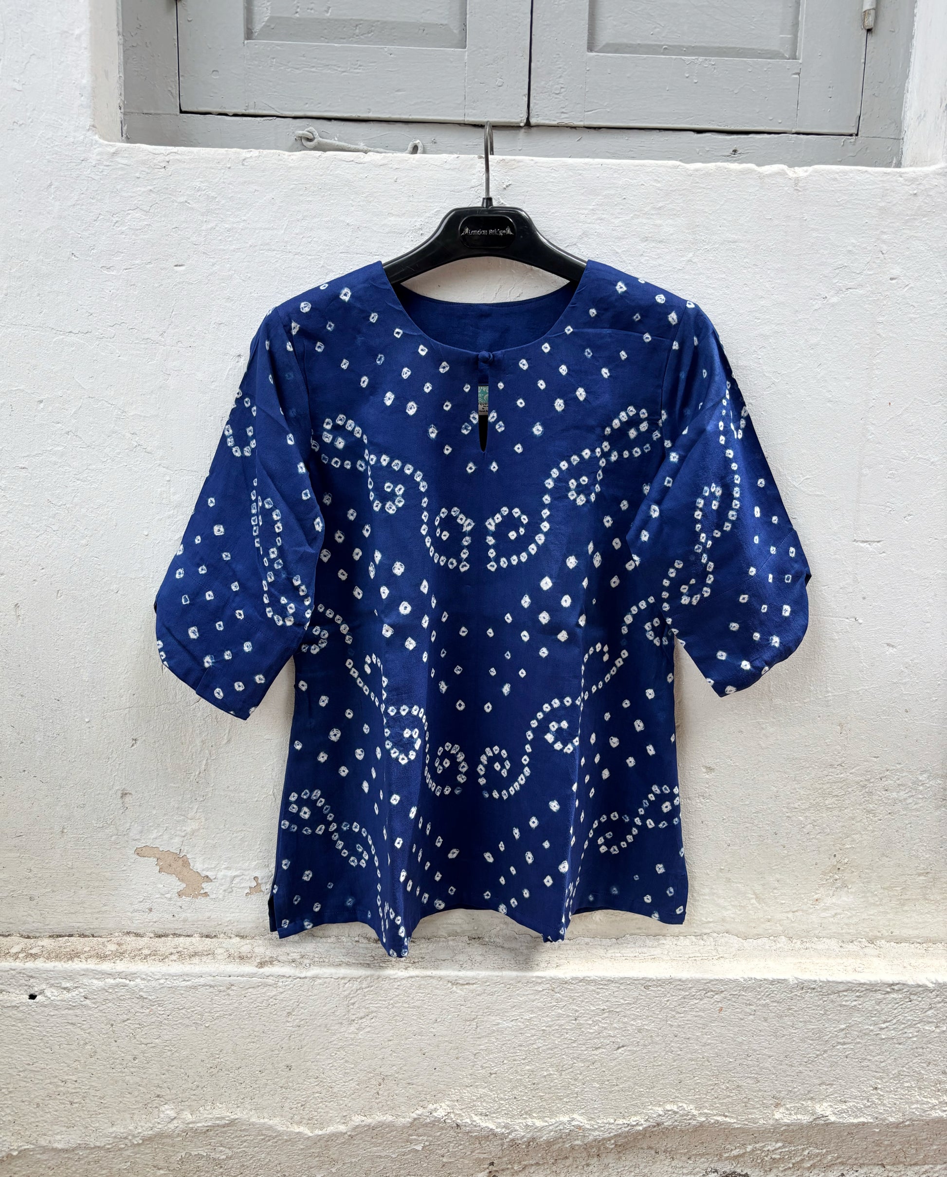 Cobalt blue cotton satin Bandhani shirt with a round neckline and keyhole opening.
