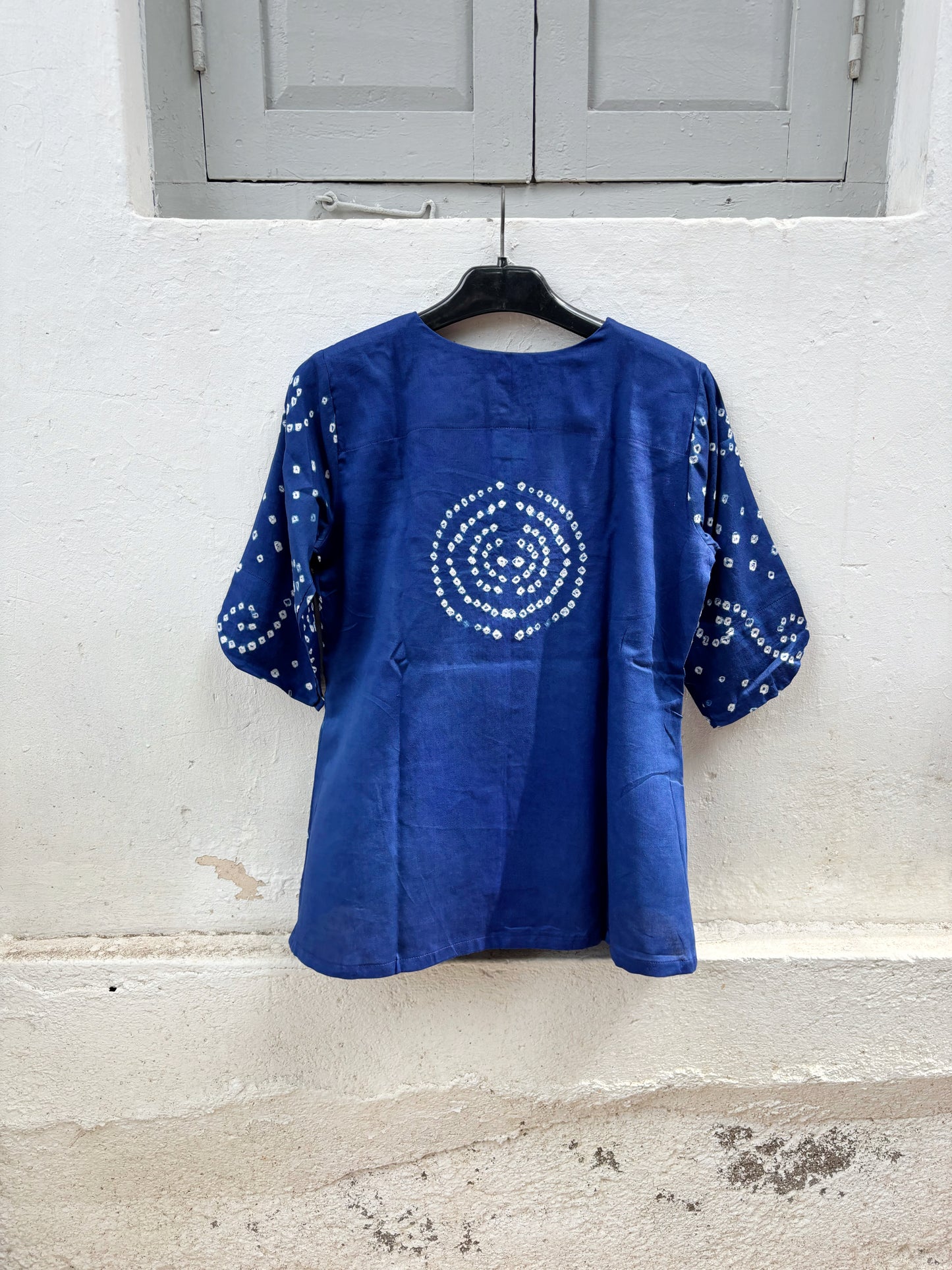 Cobalt blue cotton satin Bandhani shirt with a round neckline and keyhole opening.

