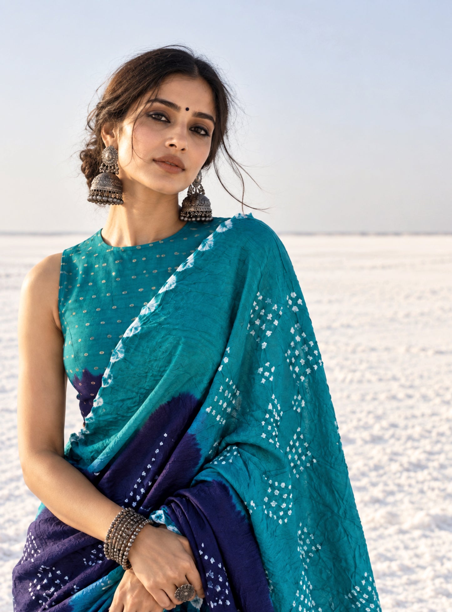Deep teal green and deep indigo hand tie-dyed Bandhani cotton saree with white floral and geometric dotted motifs
