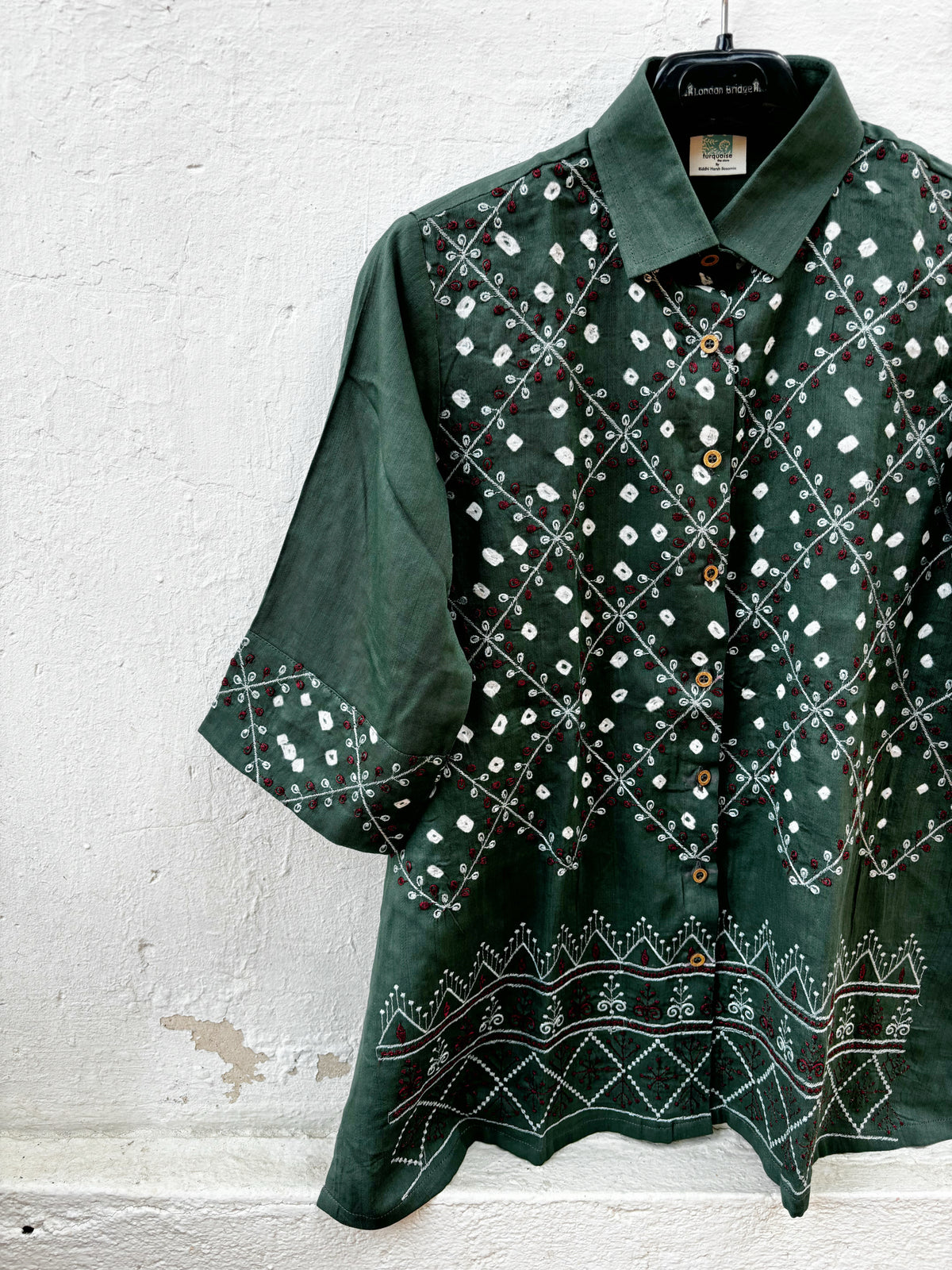 Dhani deep olive green hand tie-dyed Bandhani cotton satin shirt with ivory dots, geometric machine embroidery and embroidered borders.