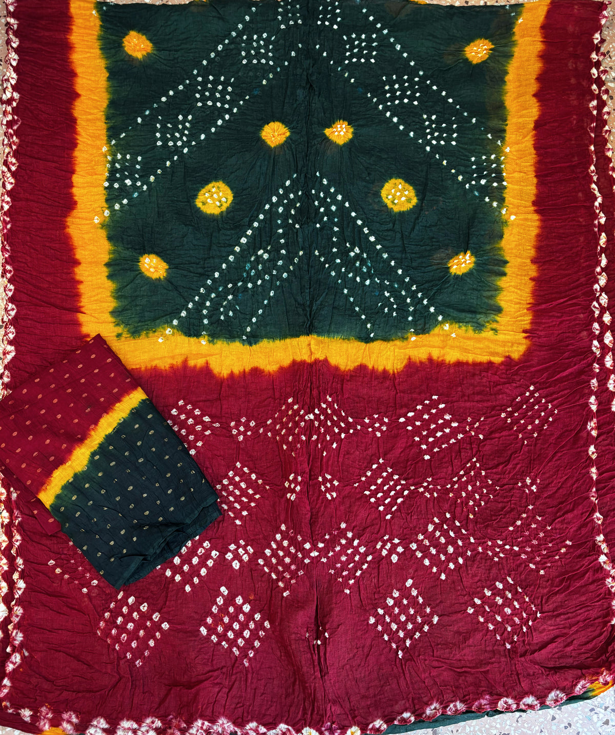 Dhun hand tie-dyed Bandhani cotton saree in deep maroon, forest green and kesari yellow with white geometric and floral motifs