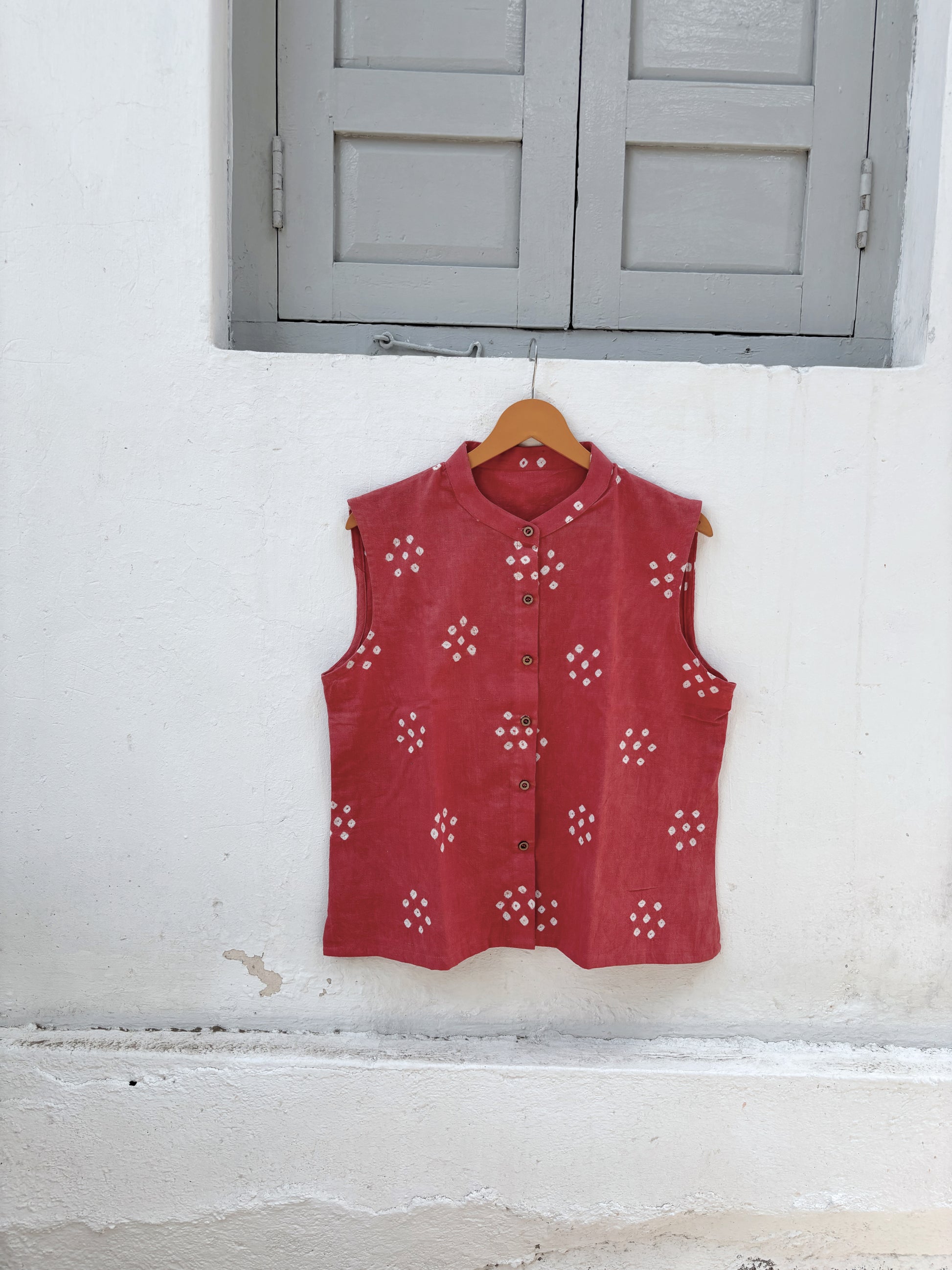 Dusty guava pink hand spun handwoven organic cotton Bandhani sleeveless shirt with white Bandhani butis and mandarin collar