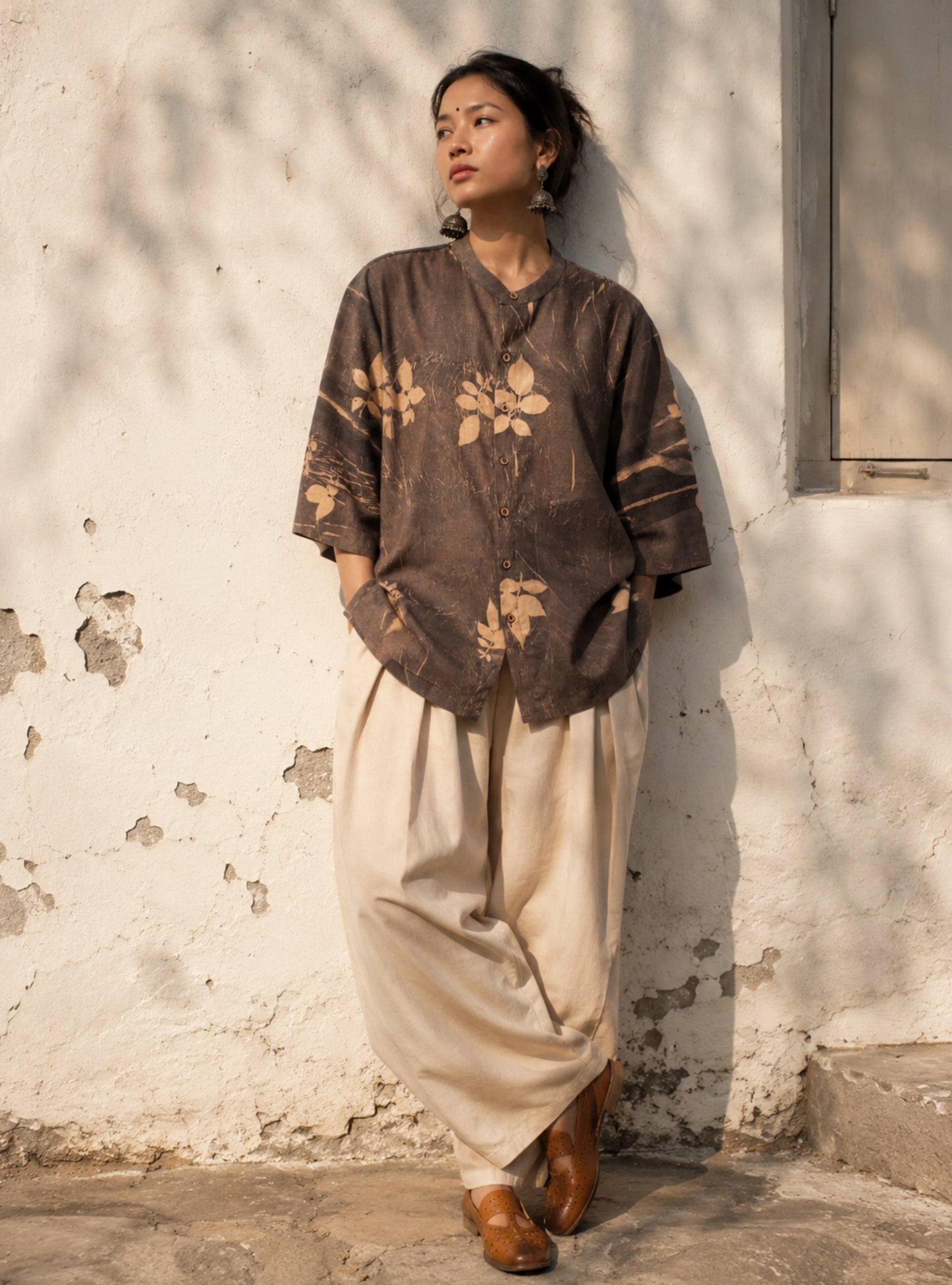 Hand-spun and hand-woven cotton shirt naturally dyed in earthy brown-grey with botanical eco prints