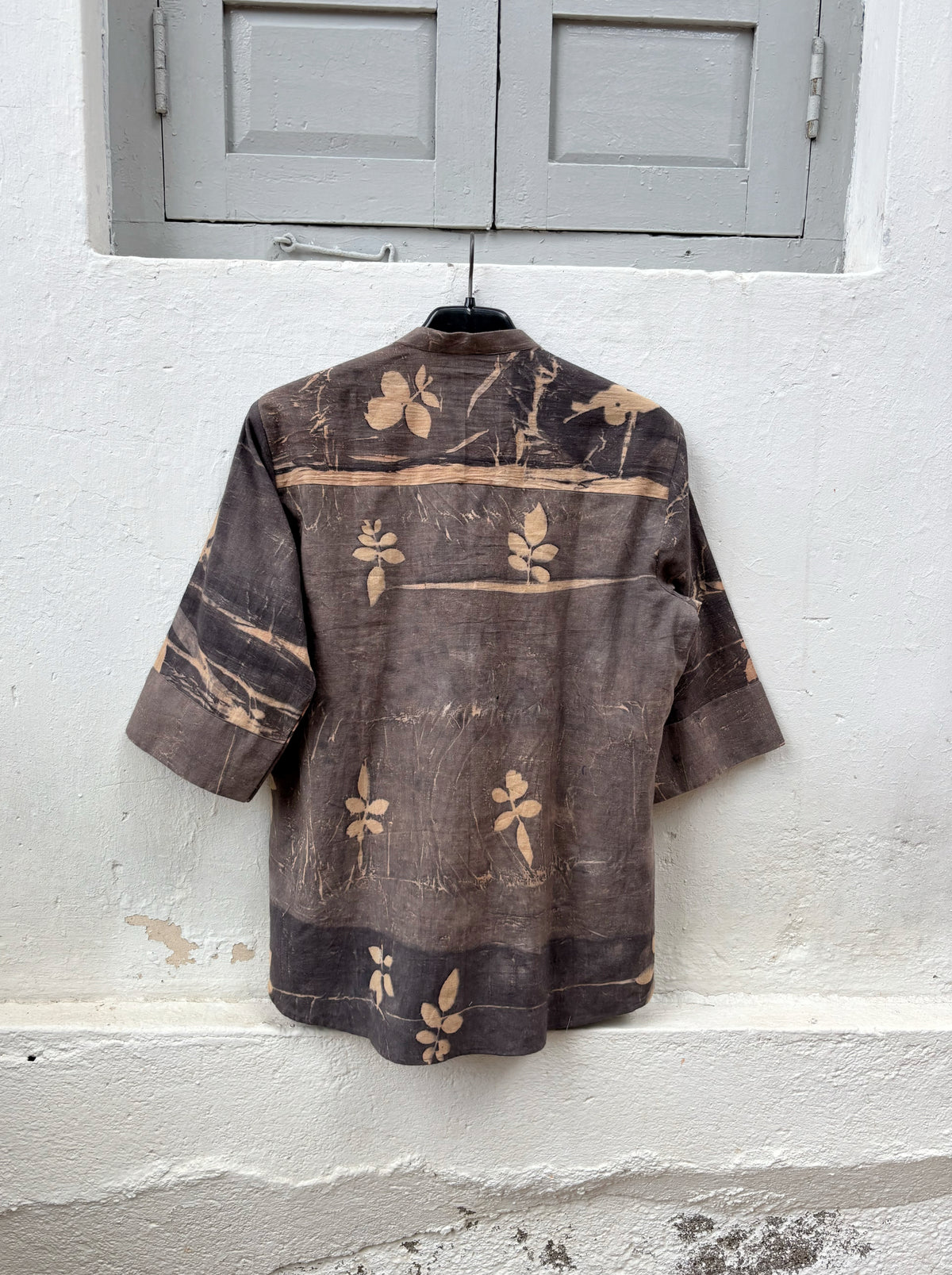 Hand-spun and hand-woven cotton shirt naturally dyed in earthy brown-grey with botanical eco prints