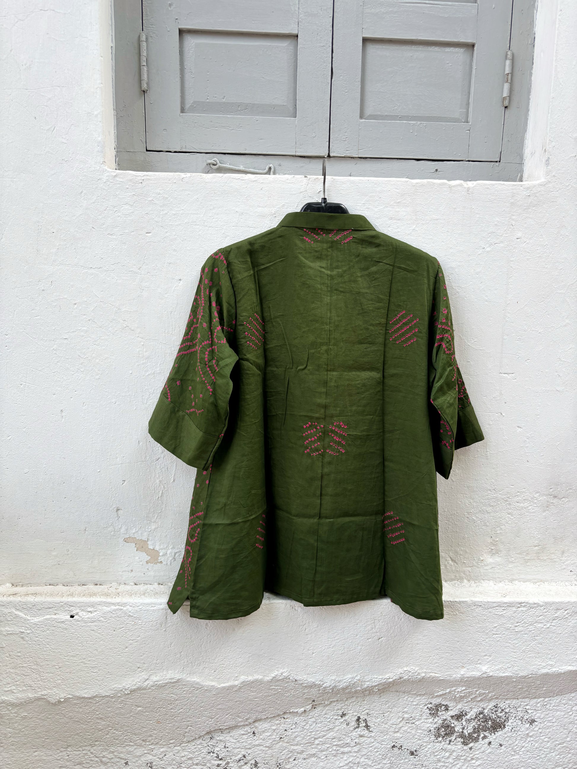 Forest olive green Jhankar Bandhani cotton shirt with berry pink motifs, soft mandarin collar, folded sleeve cuffs, coconut shell buttons and relaxed fit.