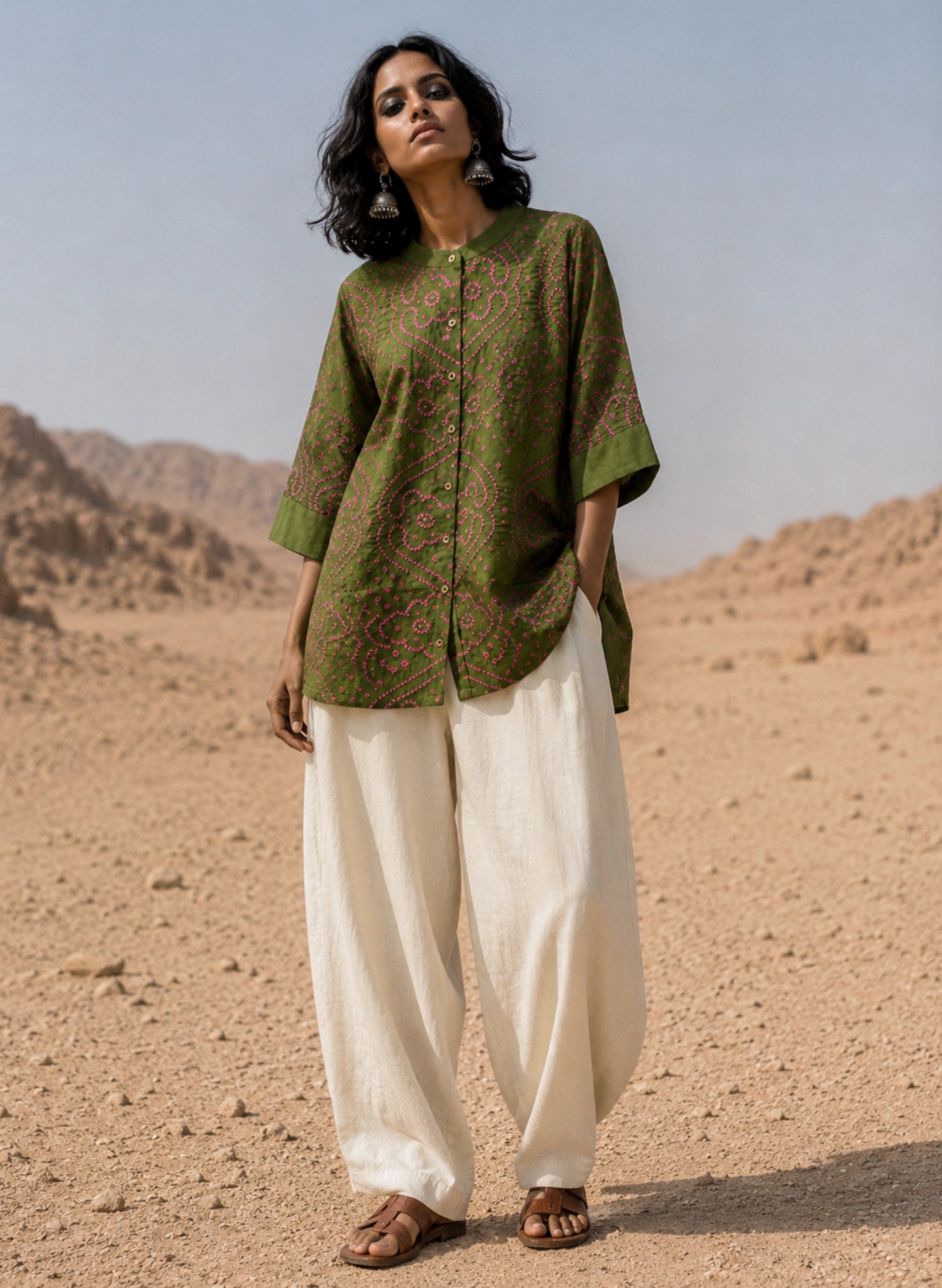 Forest olive green Jhankar Bandhani cotton shirt with berry pink motifs, soft mandarin collar, folded sleeve cuffs, coconut shell buttons and relaxed fit.
