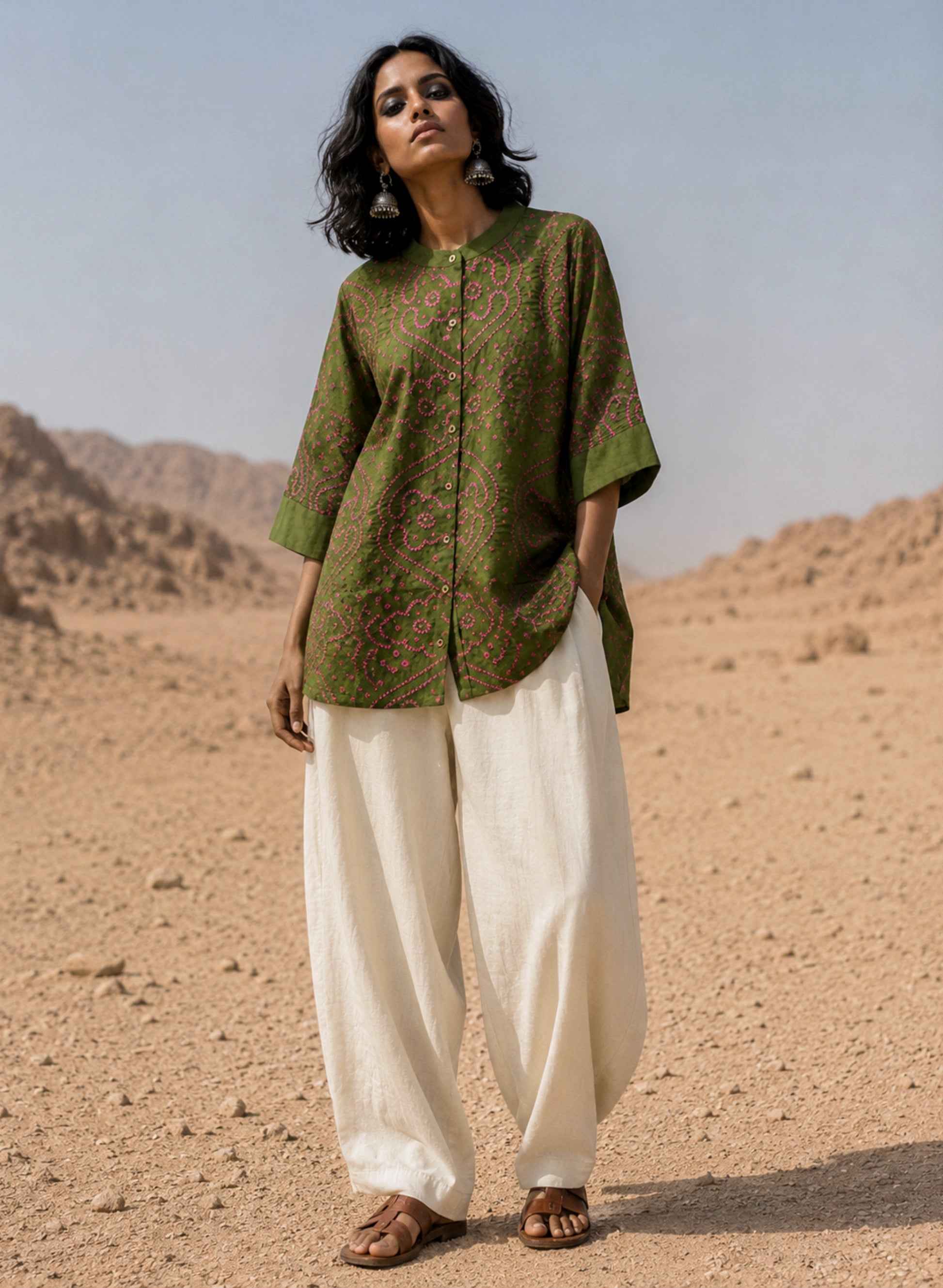 Forest olive green Jhankar Bandhani cotton shirt with berry pink motifs, soft mandarin collar, folded sleeve cuffs, coconut shell buttons and relaxed fit.
