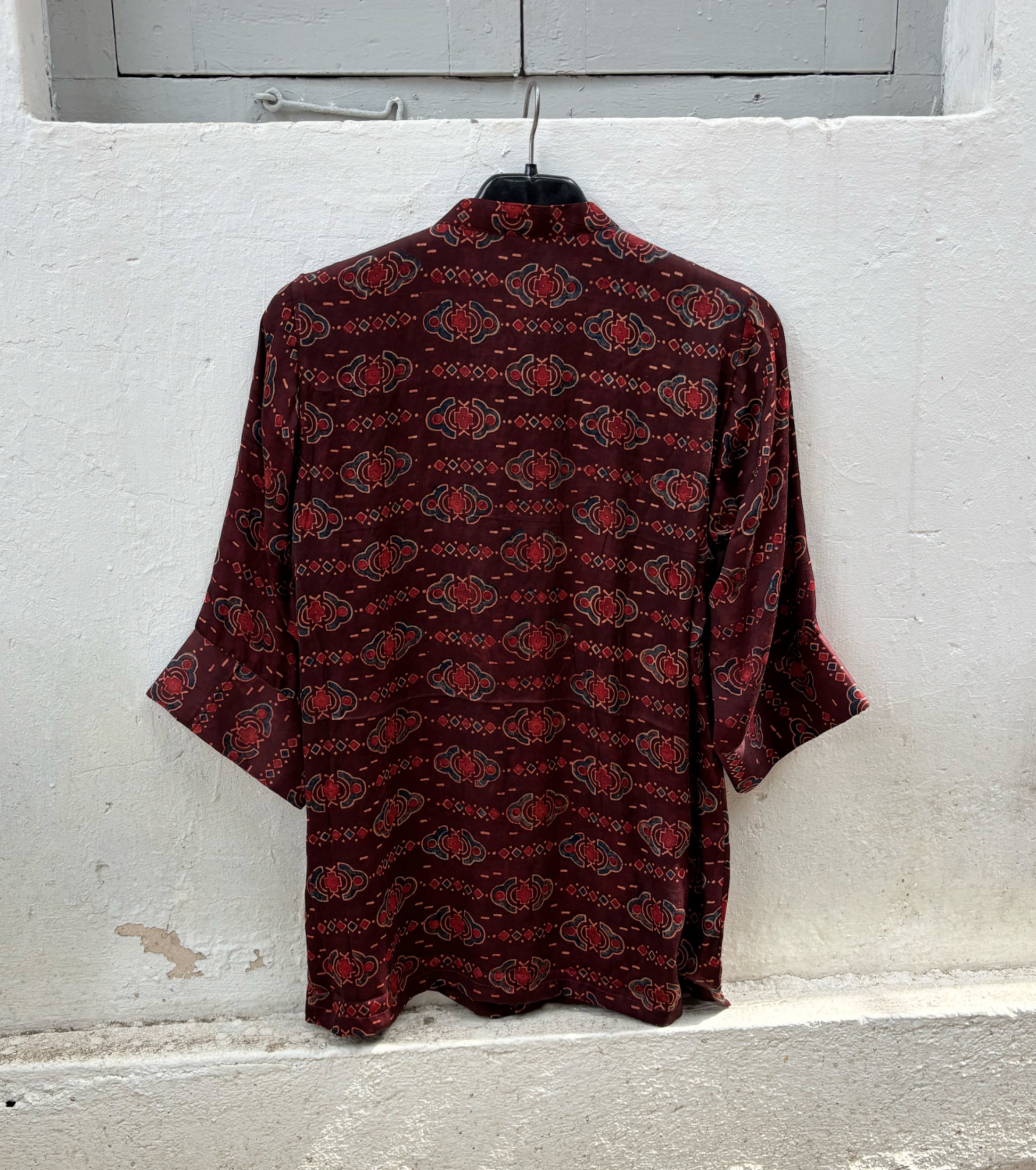 Back view of natural dyed Ajrakh hand block printed modal silk oversized shirt in deep wine maroon.
