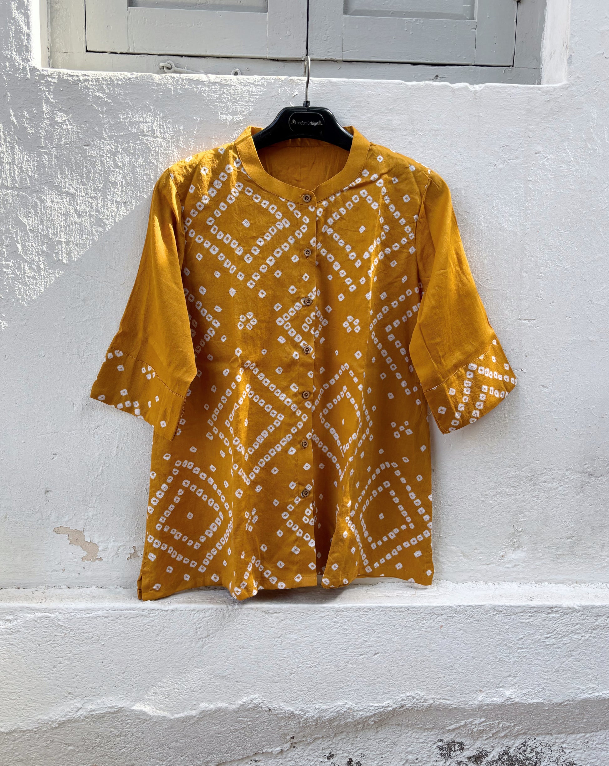 Golden Ochre hand tie-dyed Bandhani cotton satin shirt with handcrafted geometric motifs, soft mandarin collar and relaxed fit.