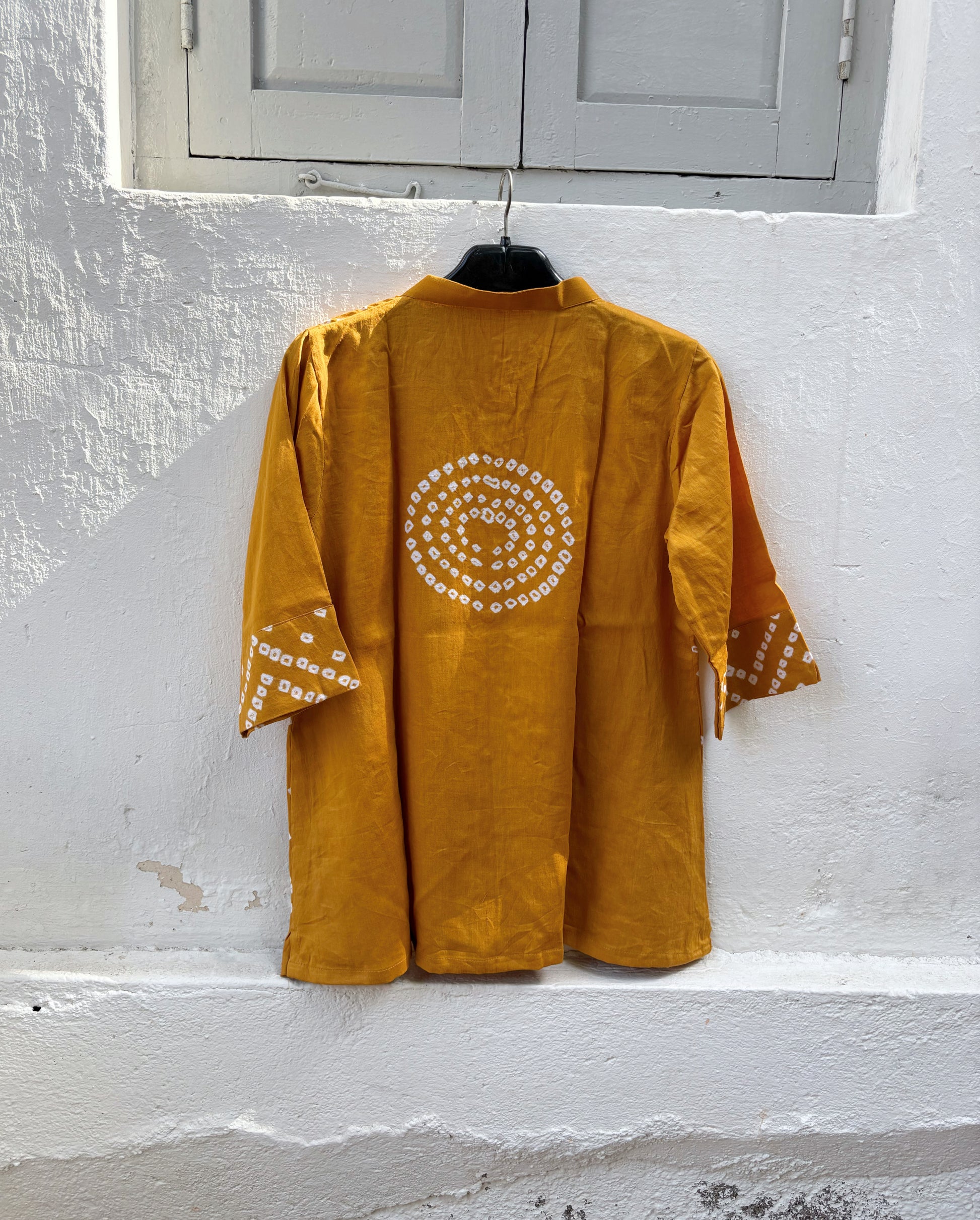 Golden Ochre hand tie-dyed Bandhani cotton satin shirt with handcrafted geometric motifs, soft mandarin collar and relaxed fit.