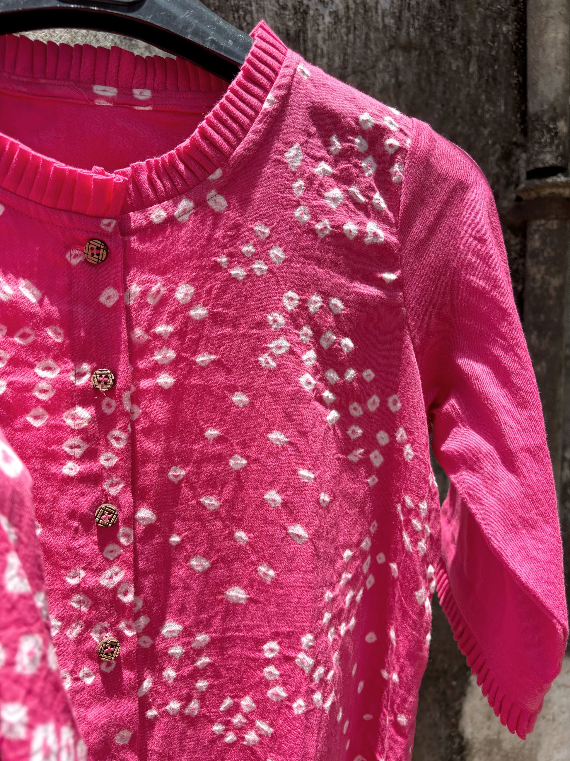 Pink Bandhani shirt for women with scattered hand tie dyed ivory dots, pleated neckline and sleeves, cotton satin relaxed fit