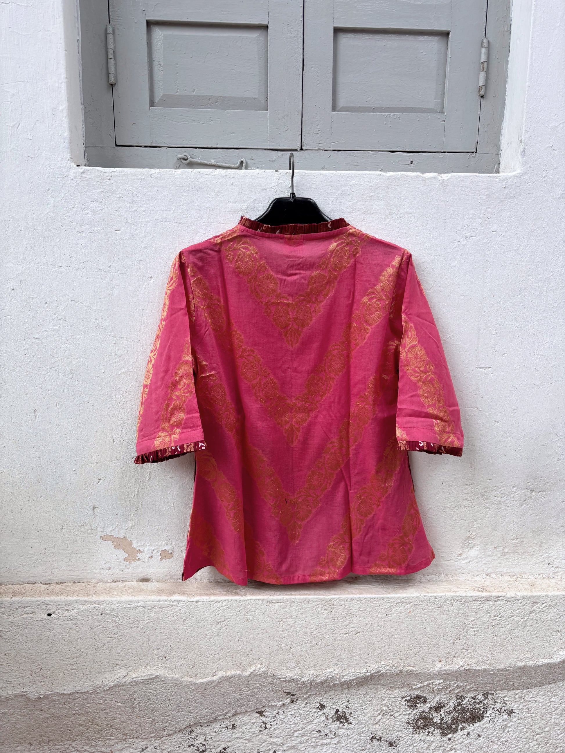 Gulabi is a dusty rose and maroon wine Bandhani cotton shirt with ivory hand-tied Bandhani, antique-gold Banarasi weaves and pleated detailing.