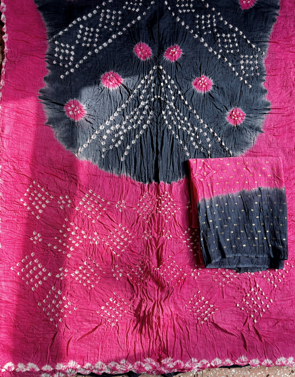 Gulabi pink and smoky navy blue hand tie-dyed Bandhani cotton saree with floral and geometric motifs
