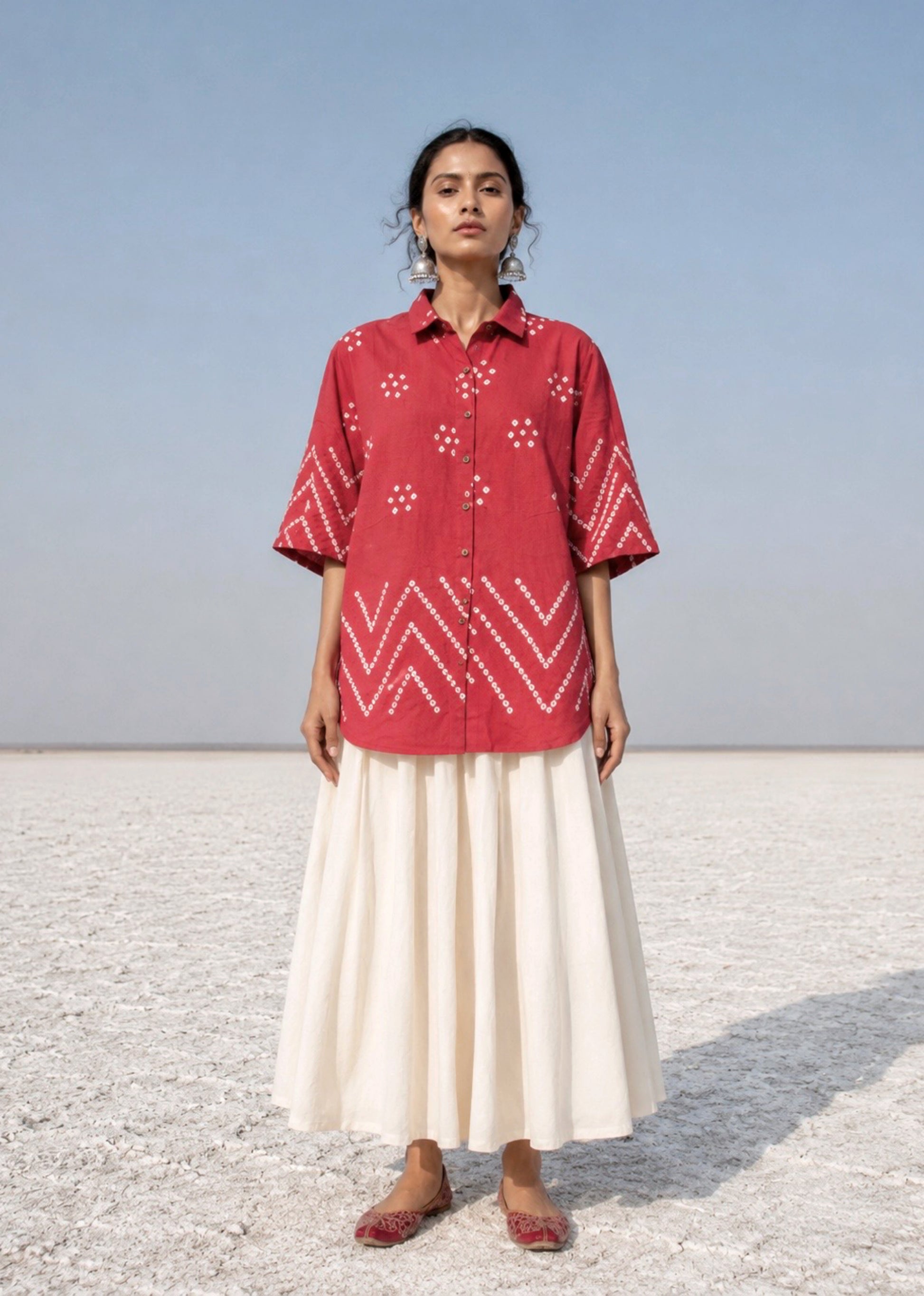 Handspun and handwoven organic cotton Bandhani shirt in muted pomegranate with handcrafted tie-dyed motifs, classic shirt collar, relaxed fit and short side slits.
