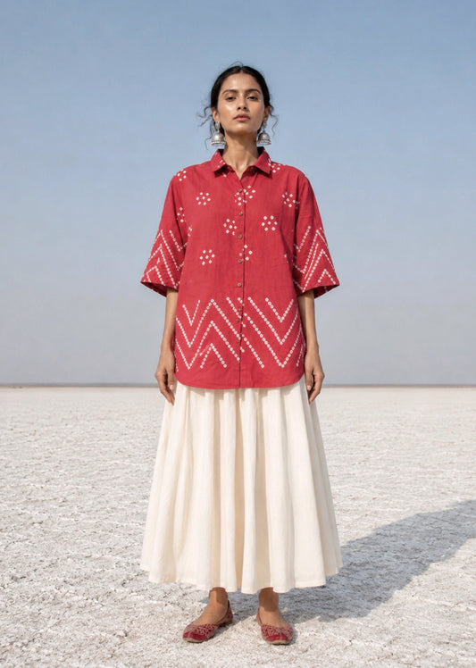 Handspun and handwoven organic cotton Bandhani shirt in muted pomegranate with handcrafted tie-dyed motifs, classic shirt collar, relaxed fit and short side slits.