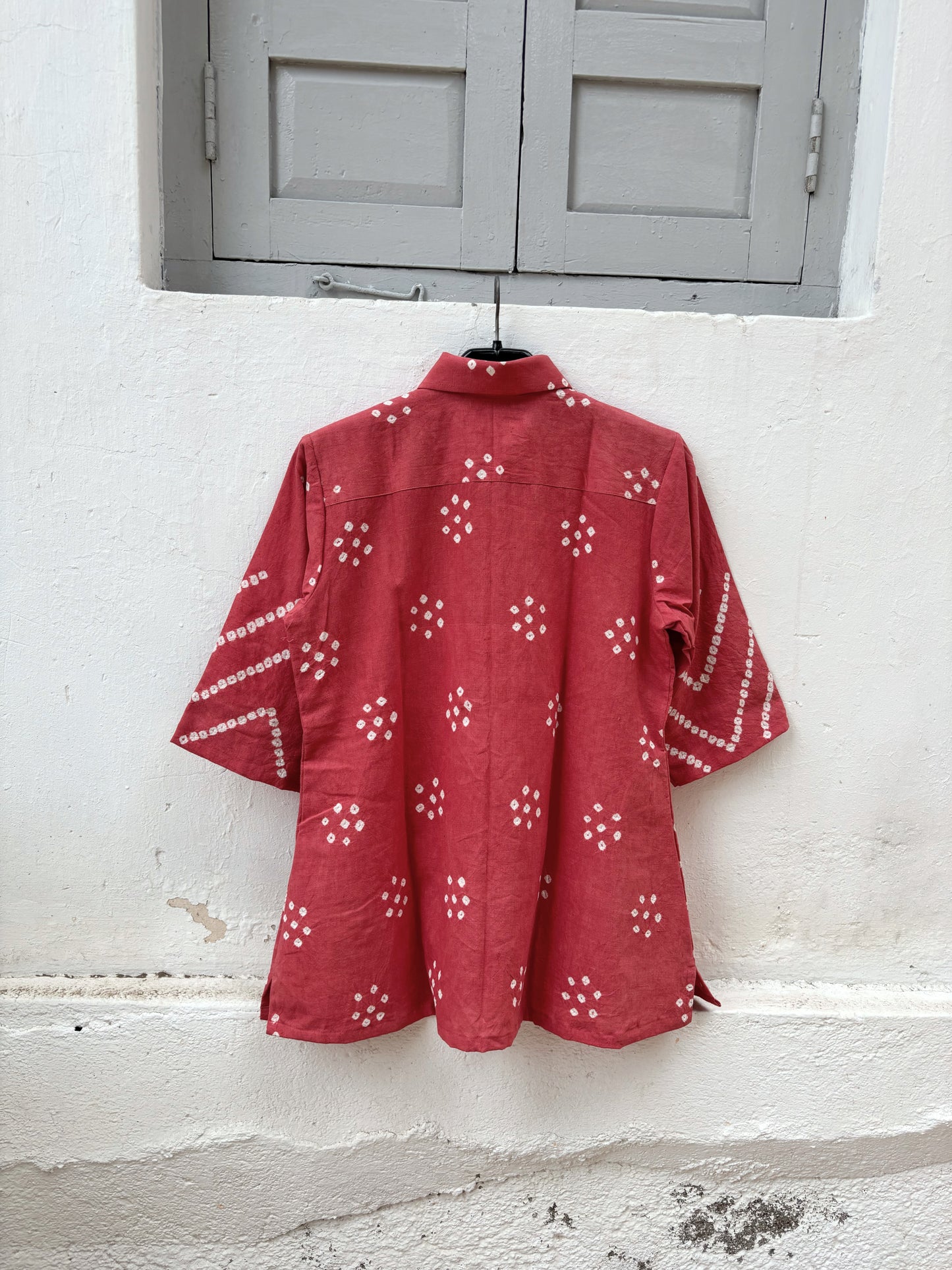 Handspun and handwoven organic cotton Bandhani shirt in muted pomegranate with handcrafted tie-dyed motifs, classic shirt collar, relaxed fit and short side slits.
