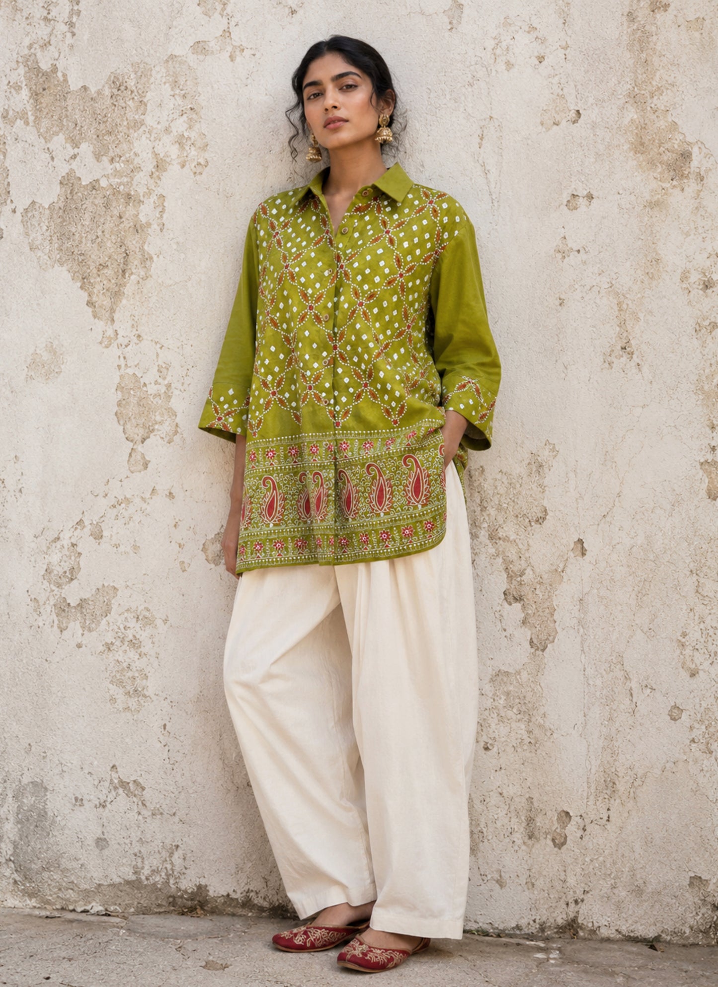 Pistachio green Bandhani cotton satin shirt with coral machine embroidery, paisley border detailing, shirt collar and relaxed fit.