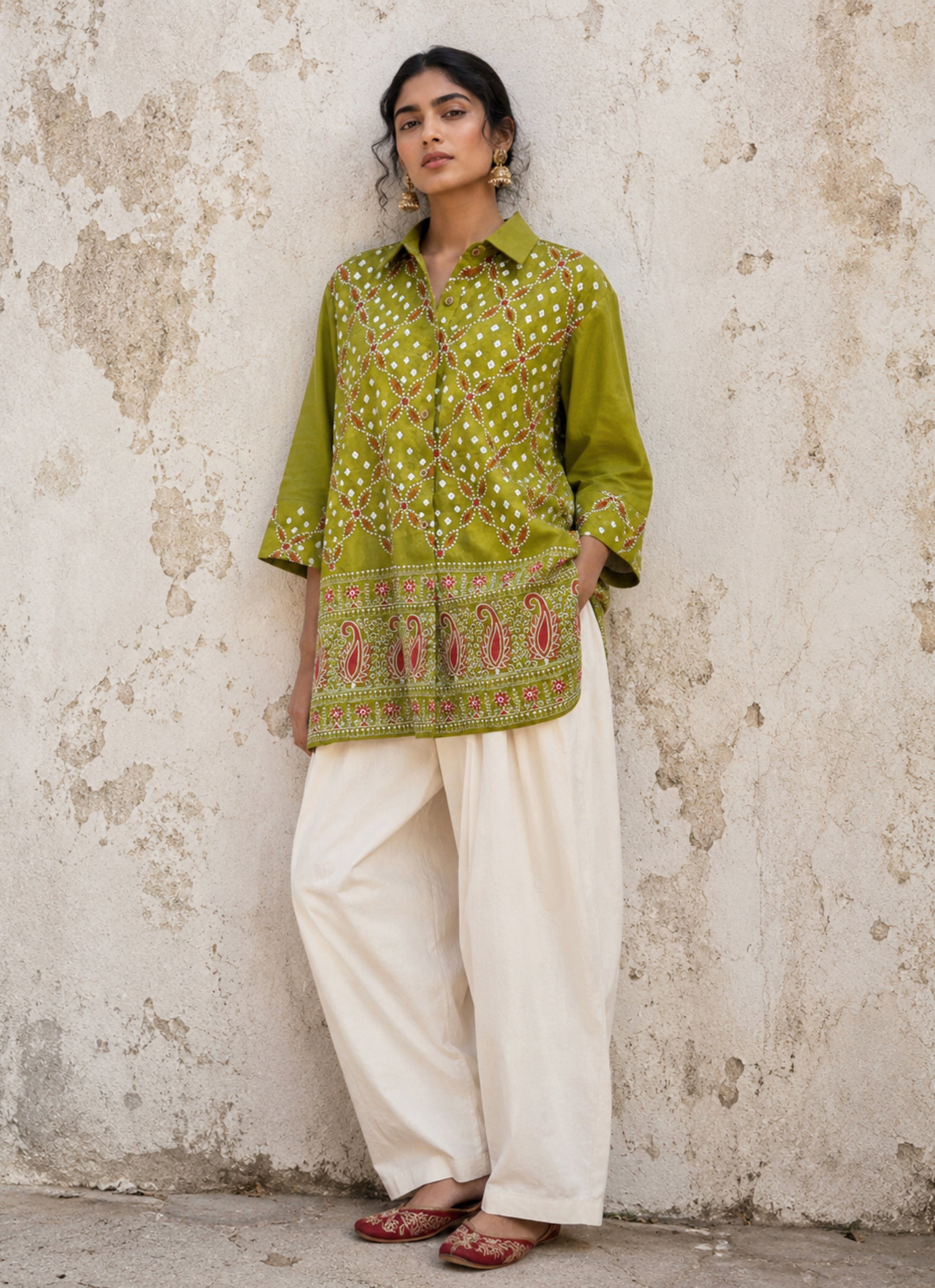 Pistachio green Bandhani cotton satin shirt with coral machine embroidery, paisley border detailing, shirt collar and relaxed fit.