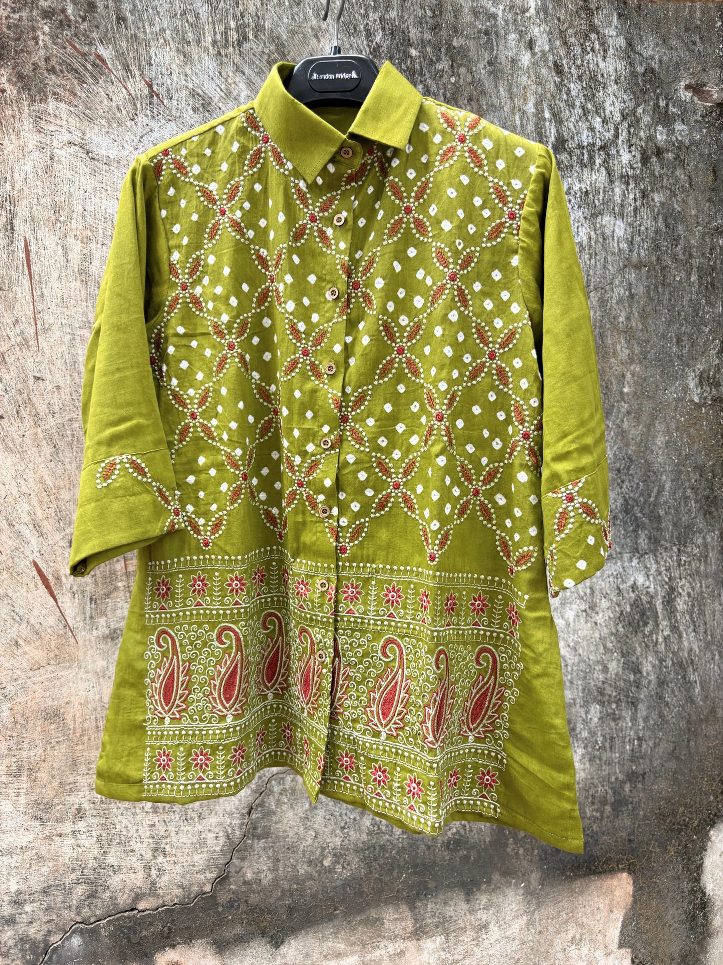Pistachio green Bandhani cotton satin shirt with coral machine embroidery, paisley border detailing, shirt collar and relaxed fit.