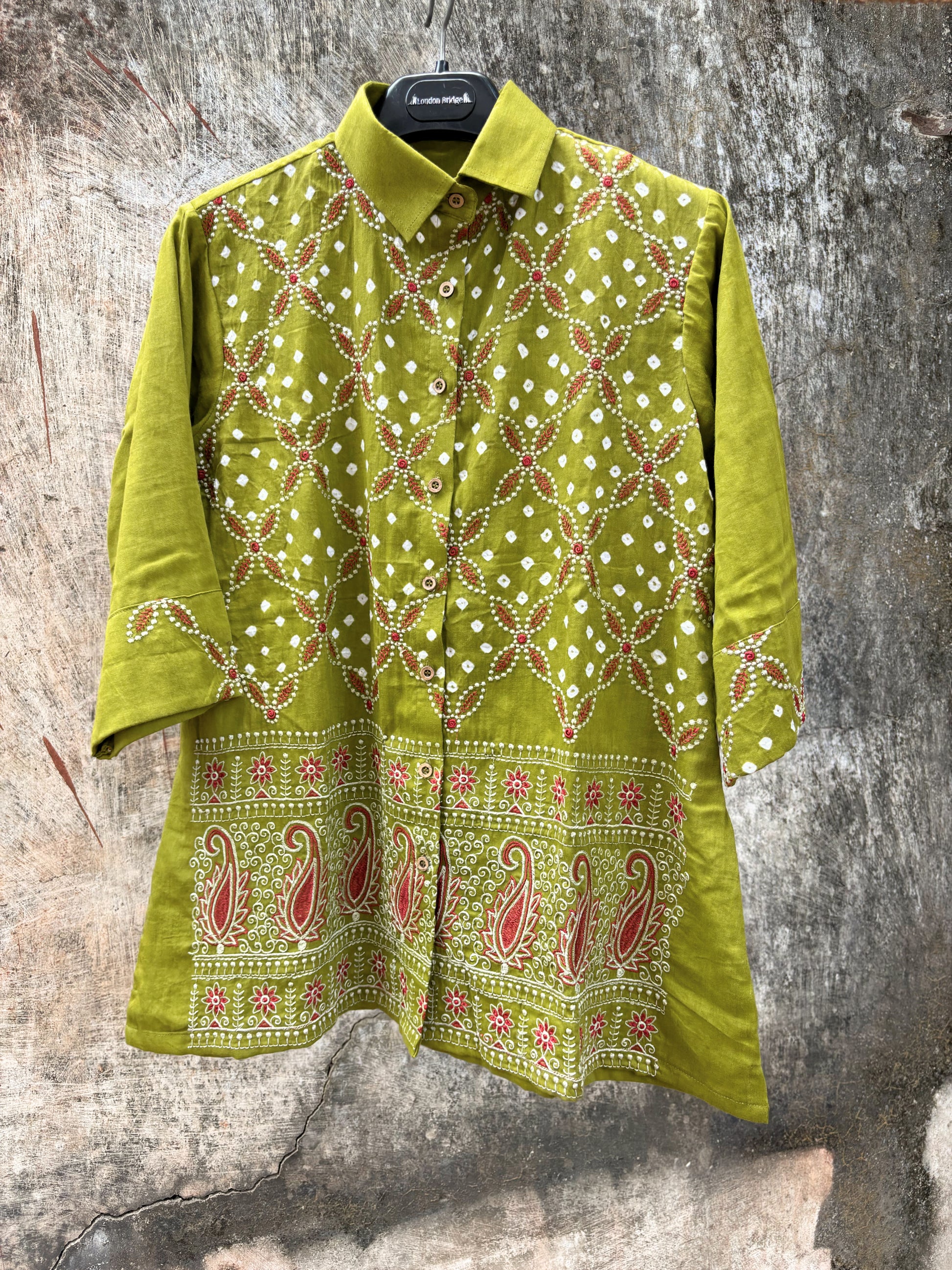 Pistachio green Bandhani cotton satin shirt with coral machine embroidery, paisley border detailing, shirt collar and relaxed fit.