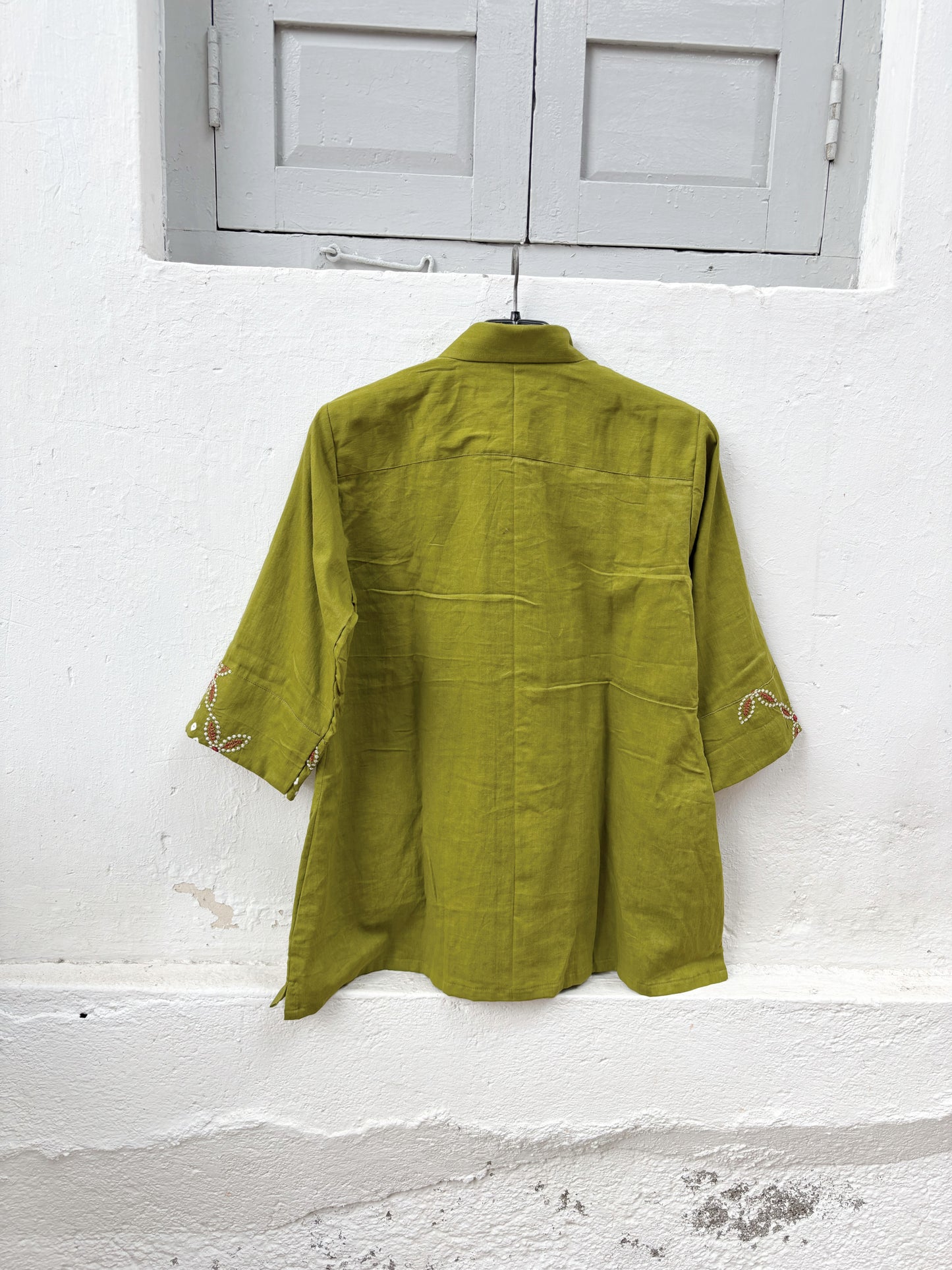 Pistachio green Bandhani cotton satin shirt with coral machine embroidery, paisley border detailing, shirt collar and relaxed fit.