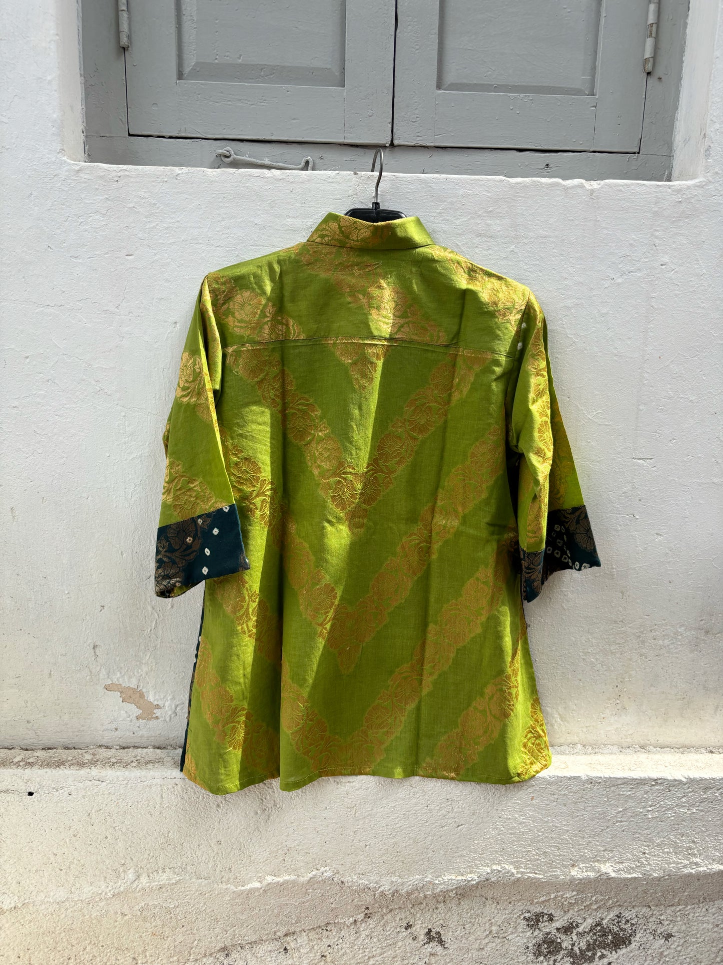 Handcrafted Bandhani festive cotton shirt in Leaf Green, Wine Maroon and Deep Teal with antique gold woven floral motifs, classic shirt collar, front button closure, relaxed fit and three-quarter sleeves.
