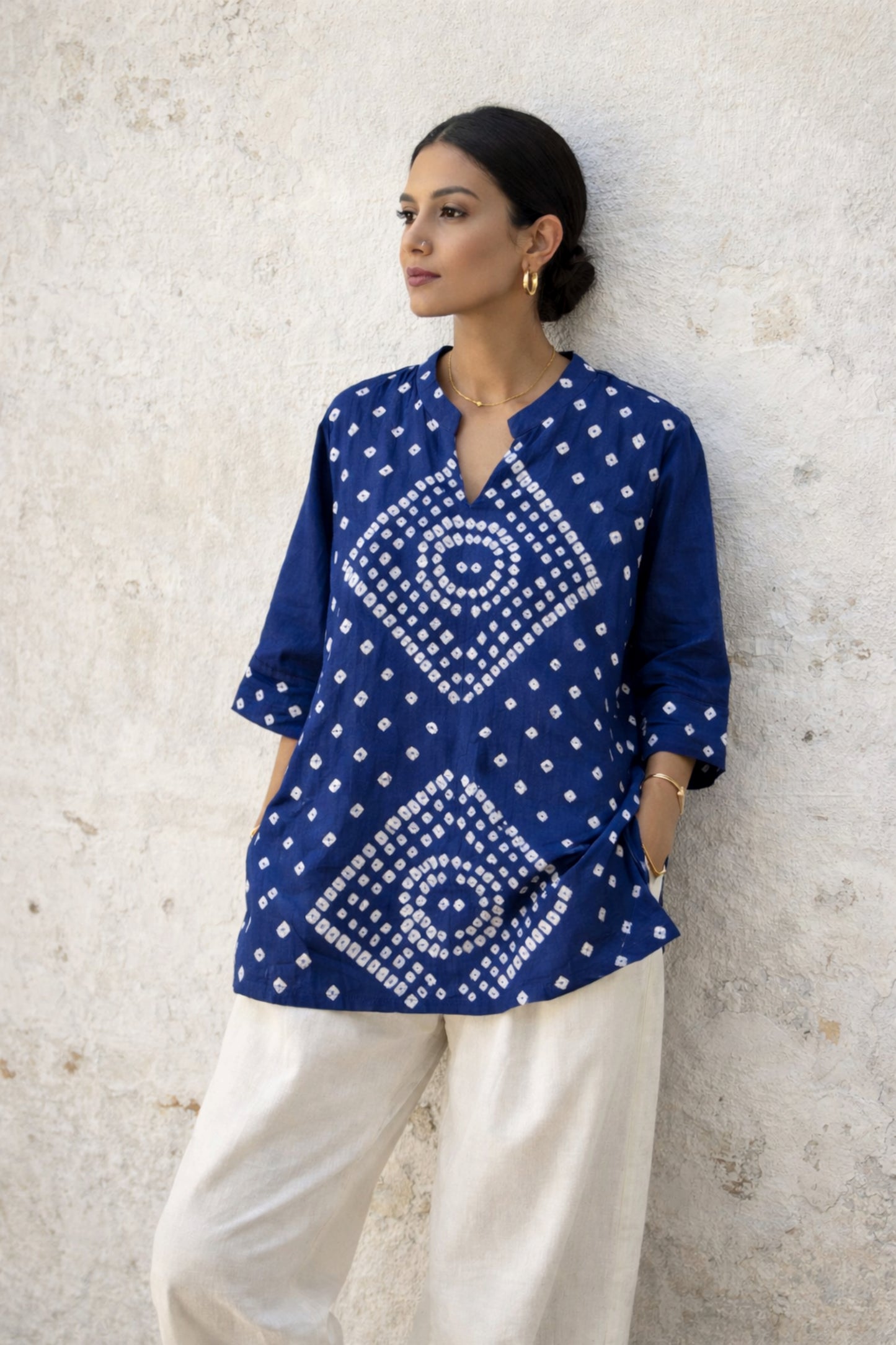 Indigo Bandhani top for women with circular chakra-inspired hand tie dyed patterns in cotton satin, relaxed fit and V-slit neckline